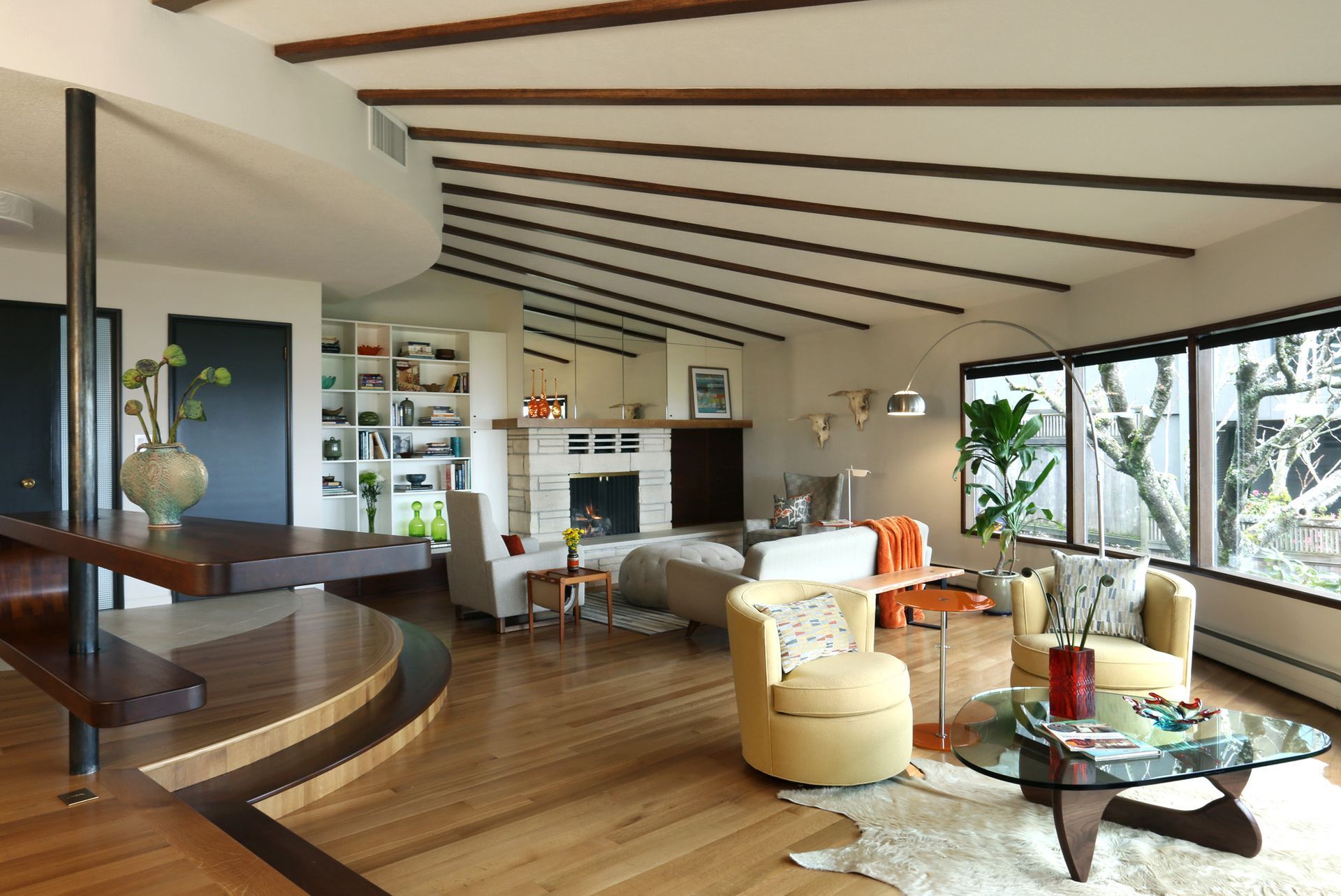 Ceiling ribs fan out over the living room from the entryway and kitchen in this 1962 midcentury modern home
