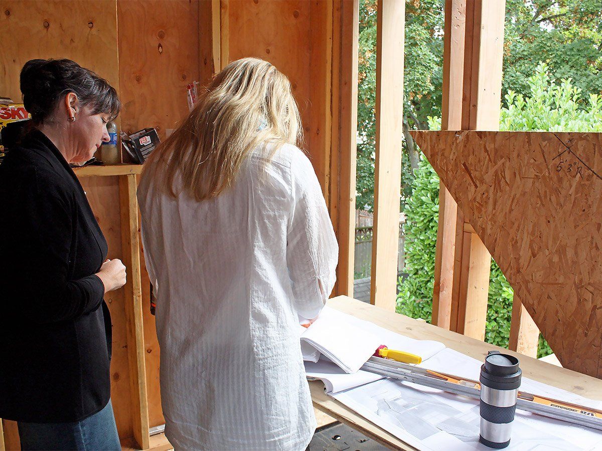 Client & Designer, reviewing the plans on site