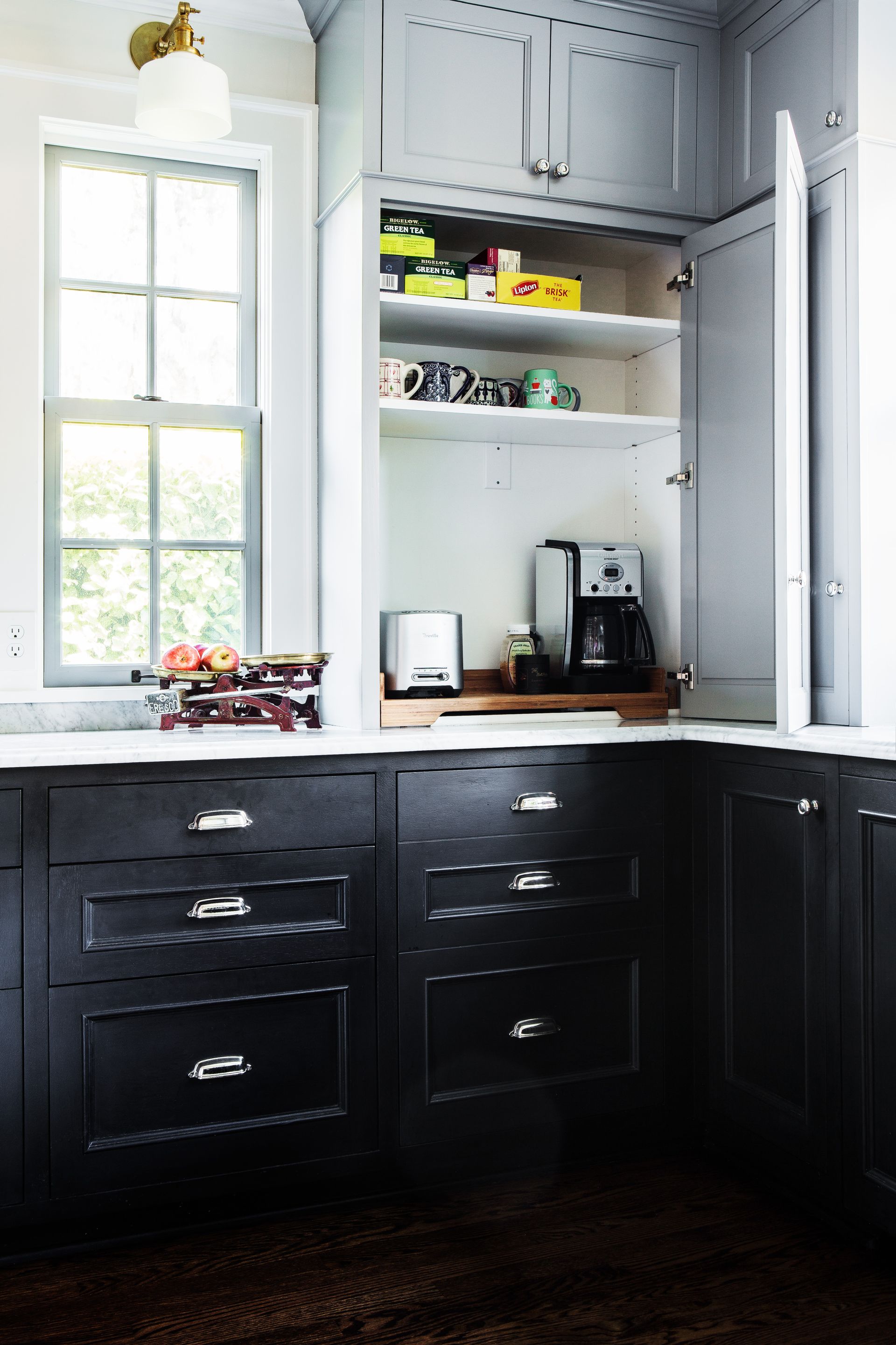 Small appliances are behind cabinet doors right on top of the counter in the corner of the kitchen.