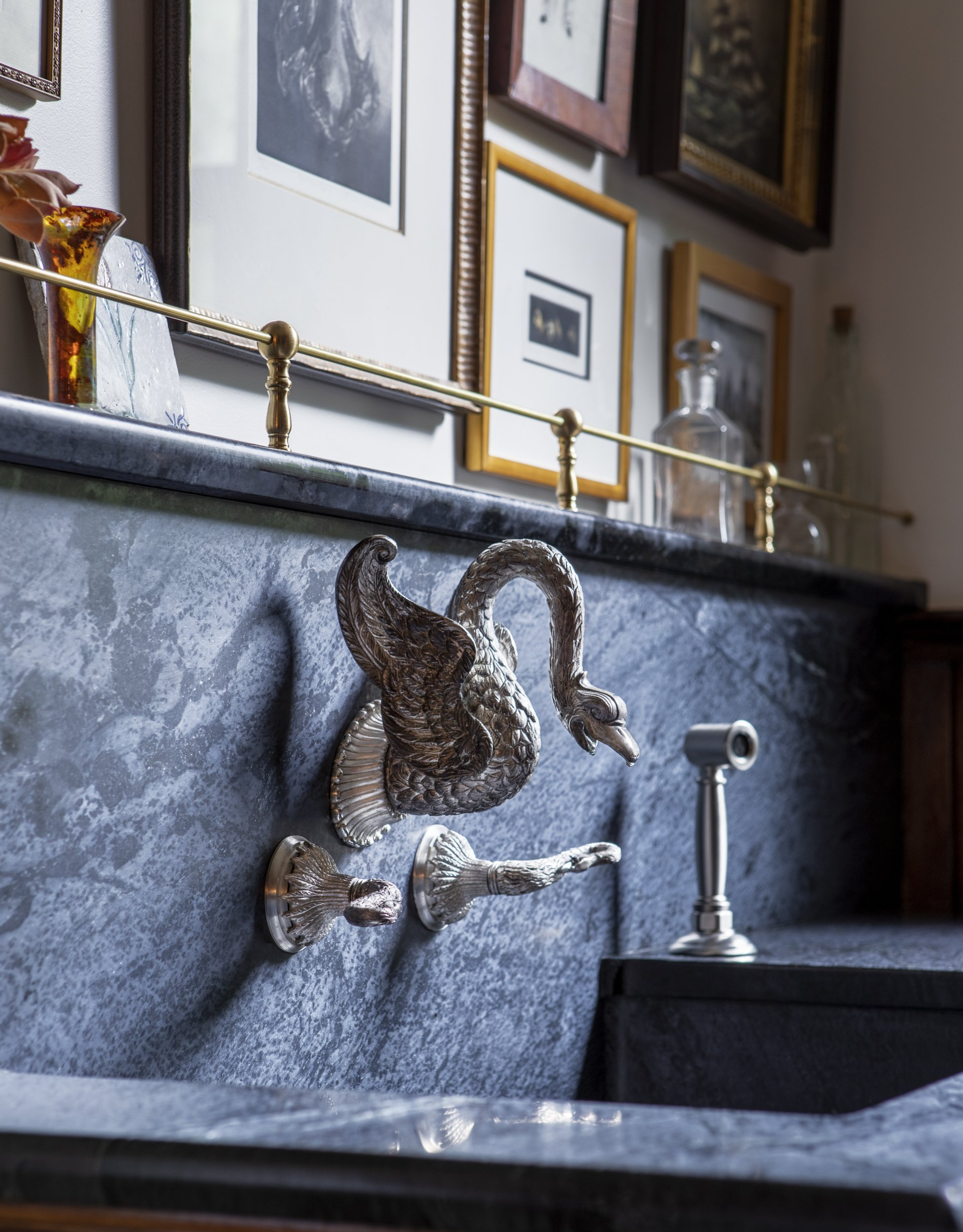 a vintage bathroom sink with an antique swan head faucet