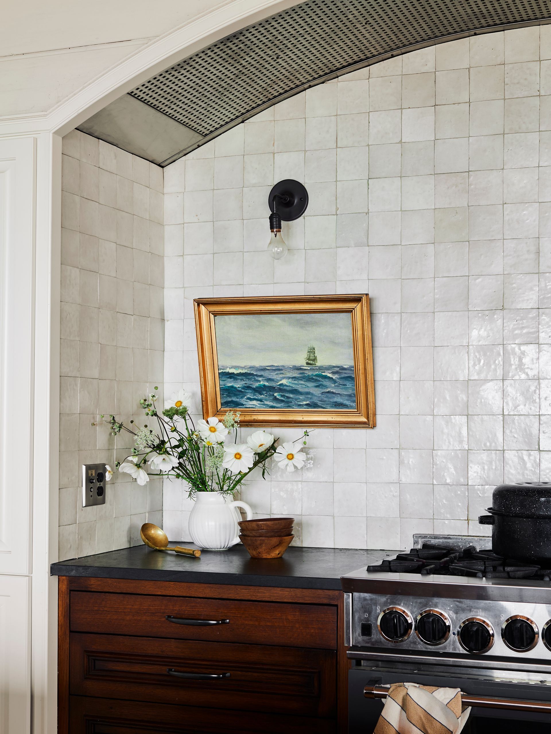 Zellige tile backsplash, soapstone counter and custom cabinetry in the open kitchen.