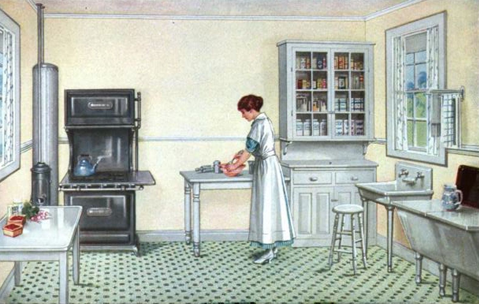  An Armstrong linoleum ad from 1918 displays a modern kitchen, with free-standing range and sink, a small work table, and a wall cabinet for storing foodstuffs and supplies. 
