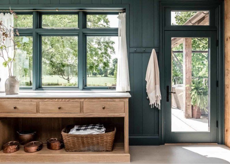 A kitchen with a wooden counter and a large window.