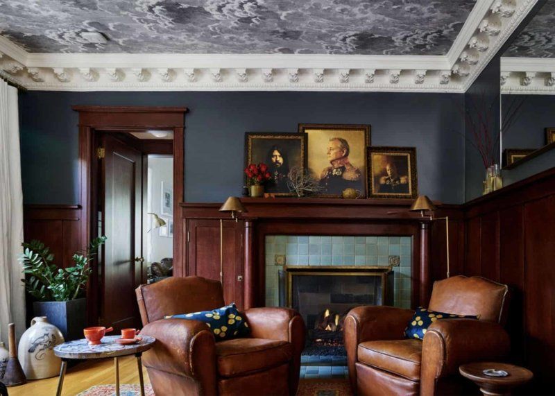A living room with two leather chairs and a fireplace