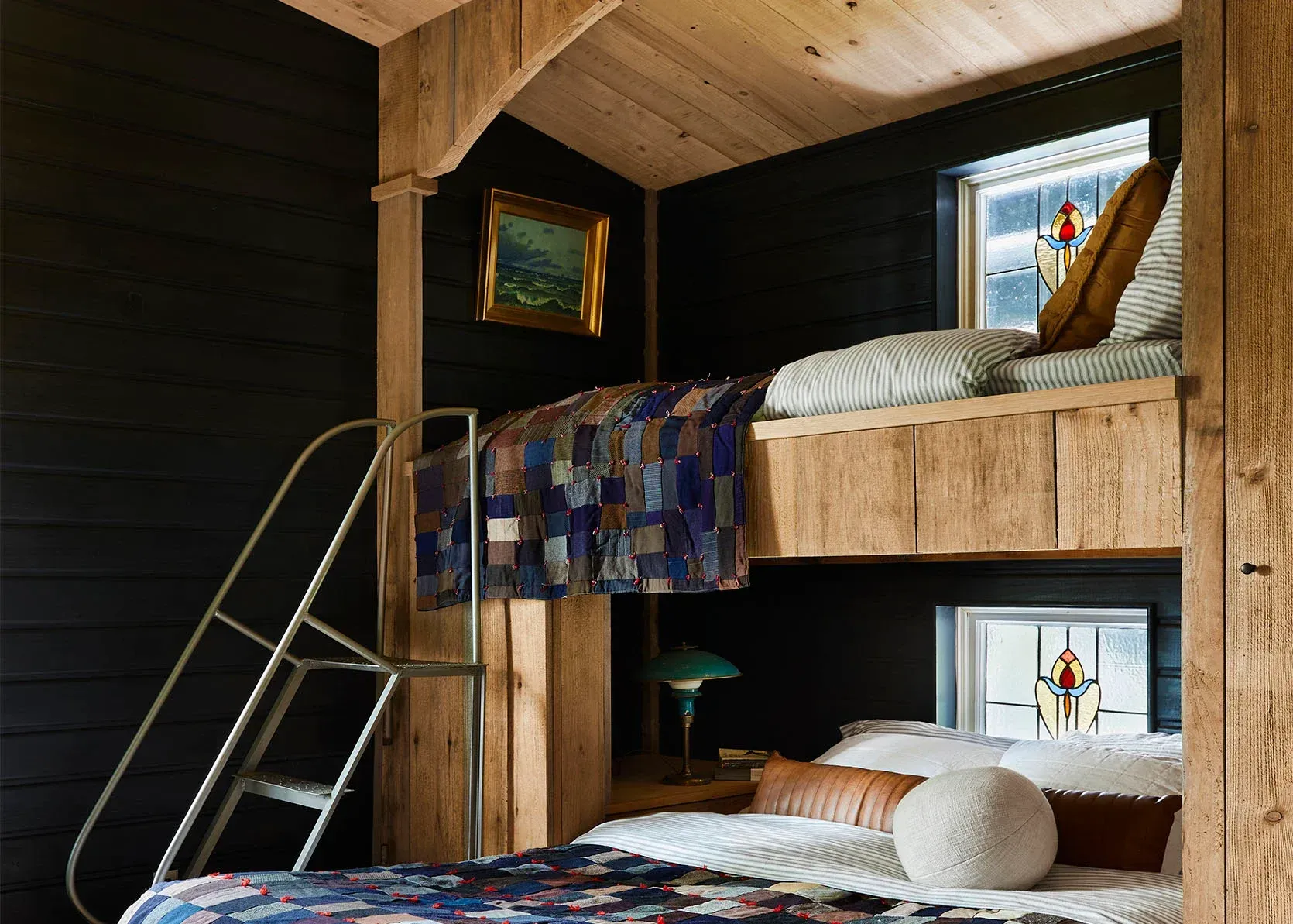 A bedroom with a bunk bed and a ladder.