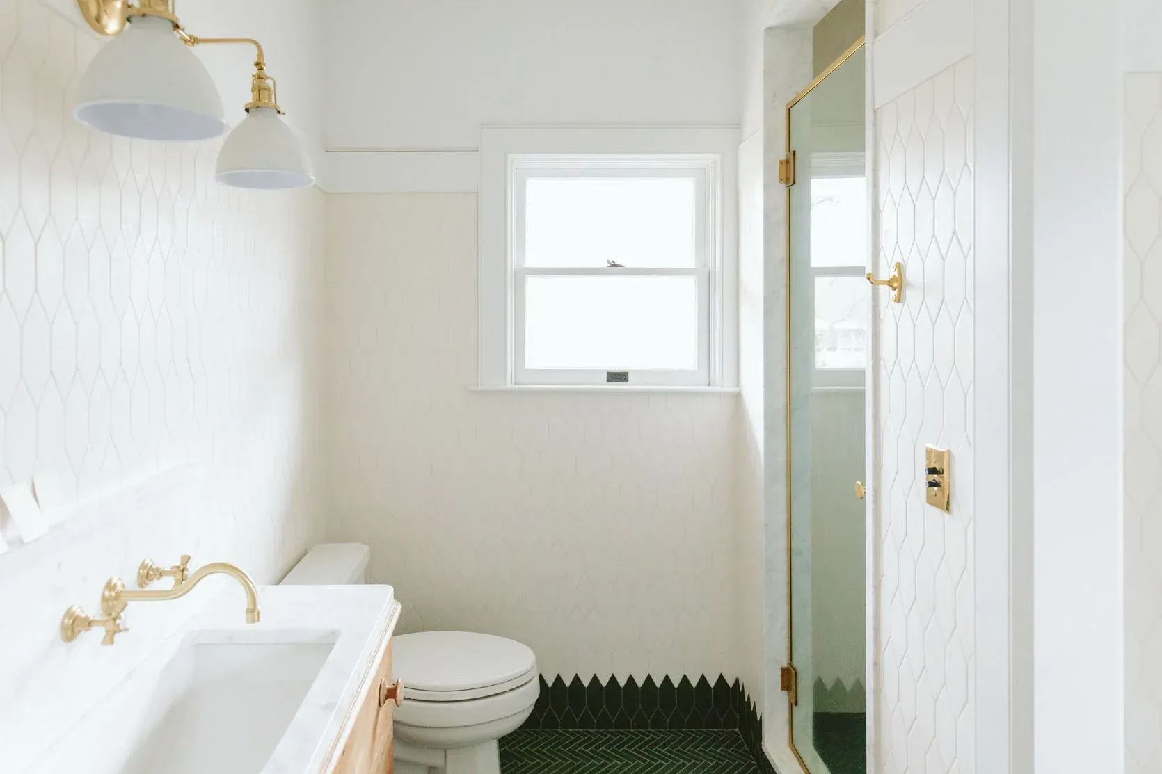 A bathroom with a toilet , sink , and shower.