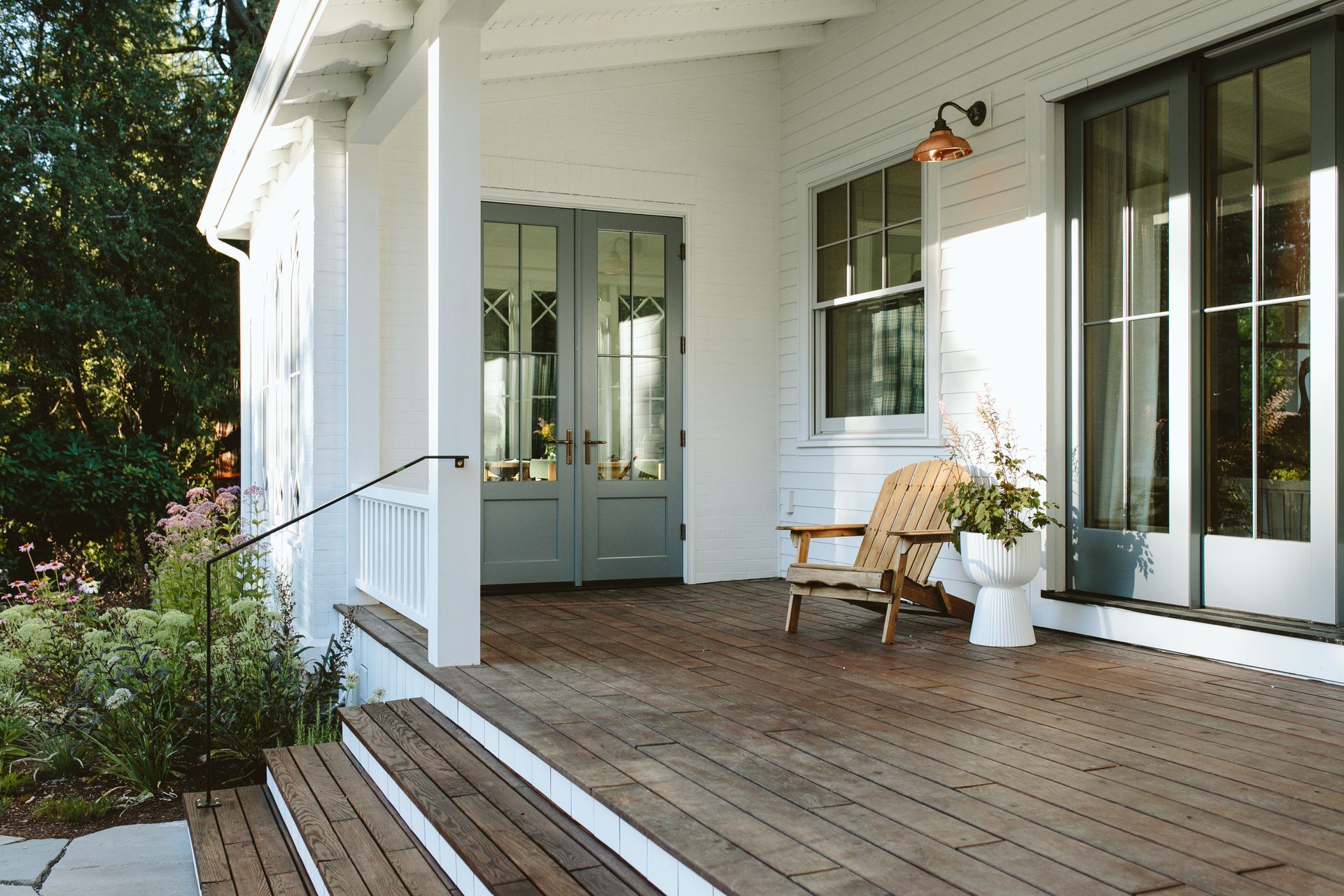 Porch addition with a vaulted ceiling and Sapele decking leads to the sunroom below the same roofline.