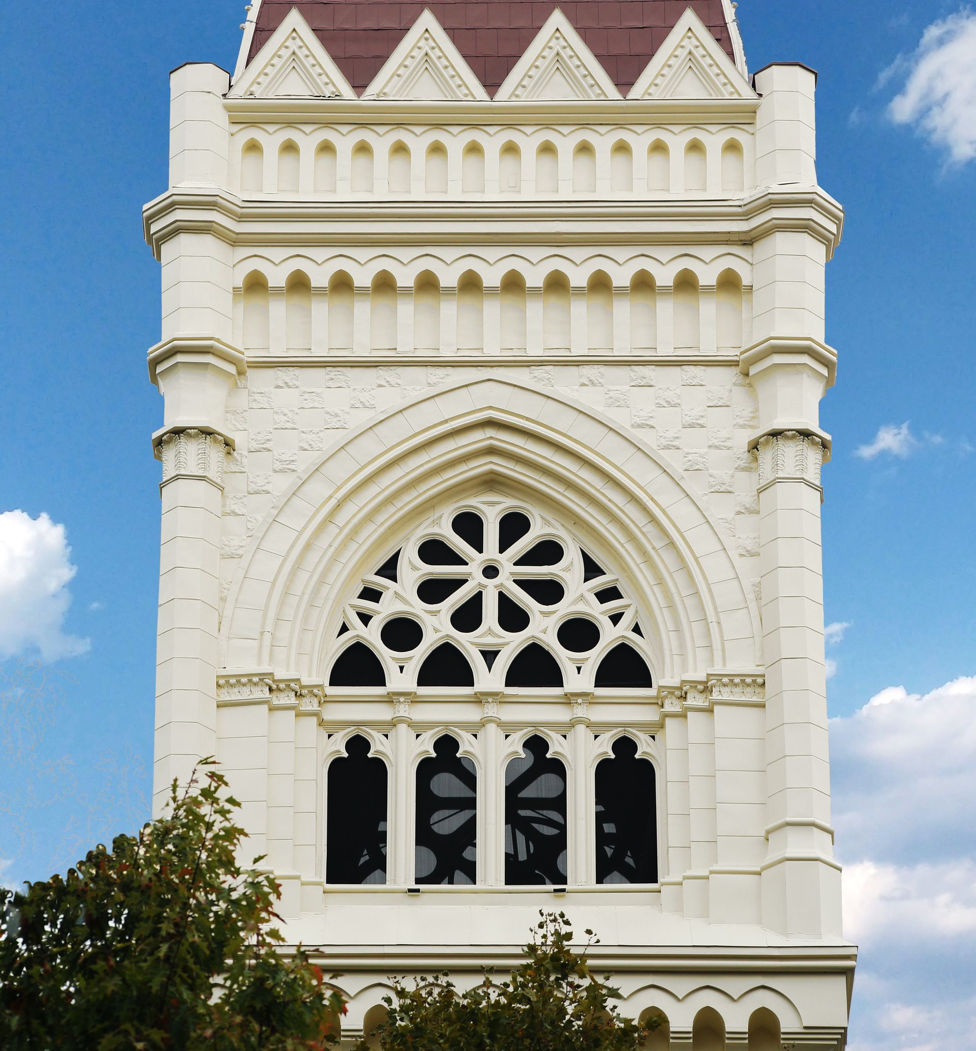 A very tall white building with a red roof