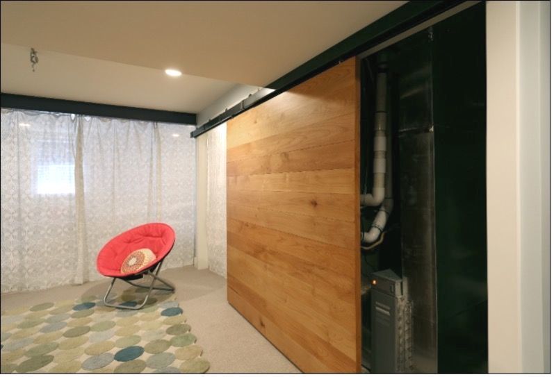 Picture of home plumbing and HVAC system being hidden behind a basement wall