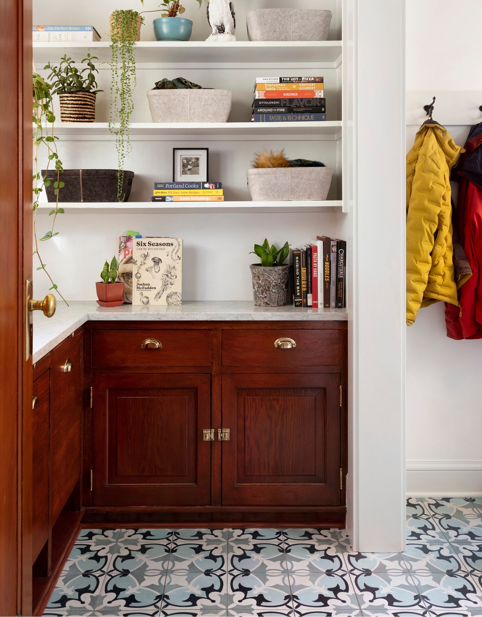 Arciform utilized a small pass-through space off the kitchen to create a small pantry area in this 1911 Irvington craftsman. Stained fir cabinets, unlacquered brass hardware, and marble counters are in keeping with the home's era. 