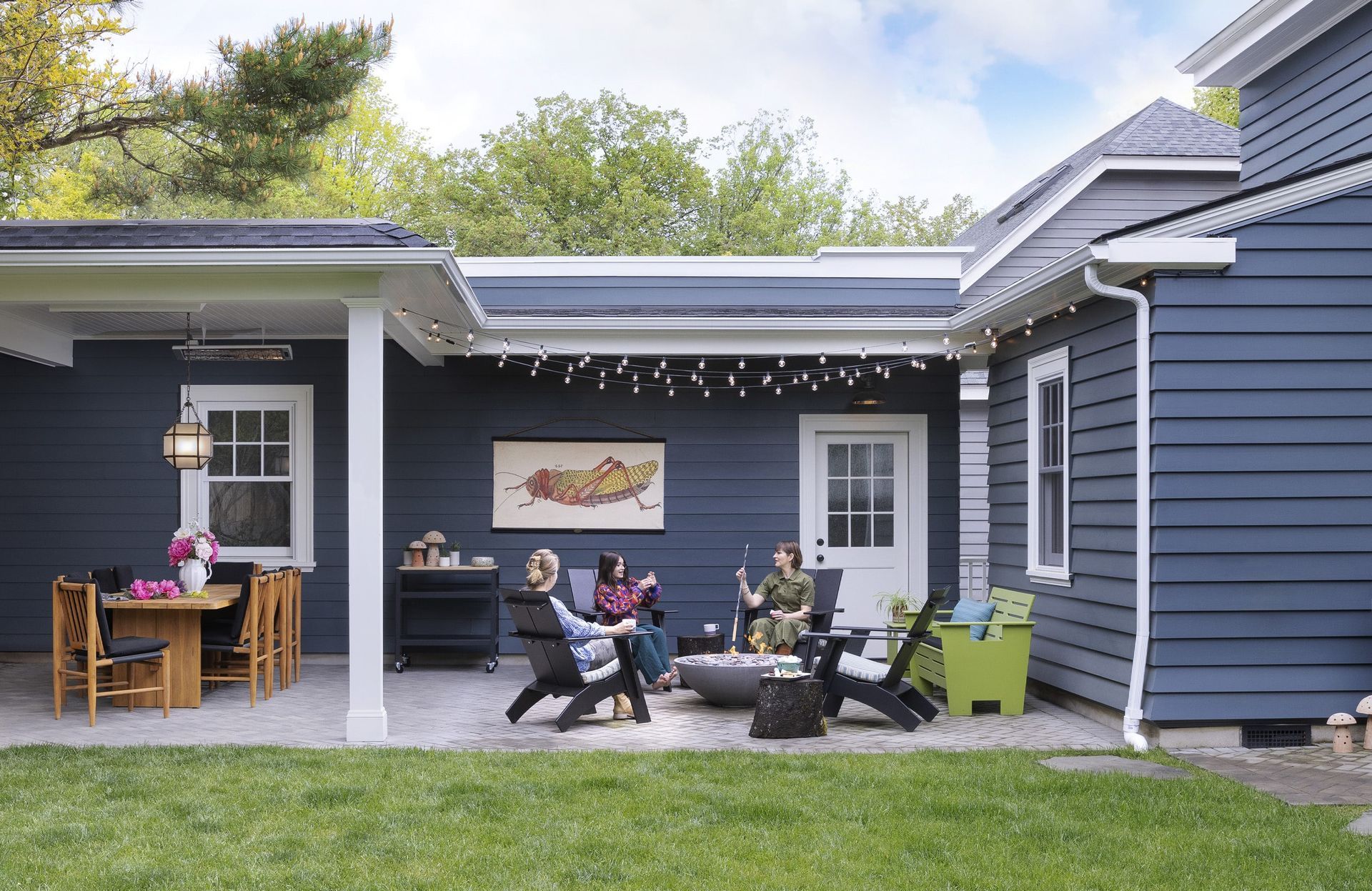 The new back patio is partially covered with a table for entertaining and a firepit for making s'mores open to the sky. 