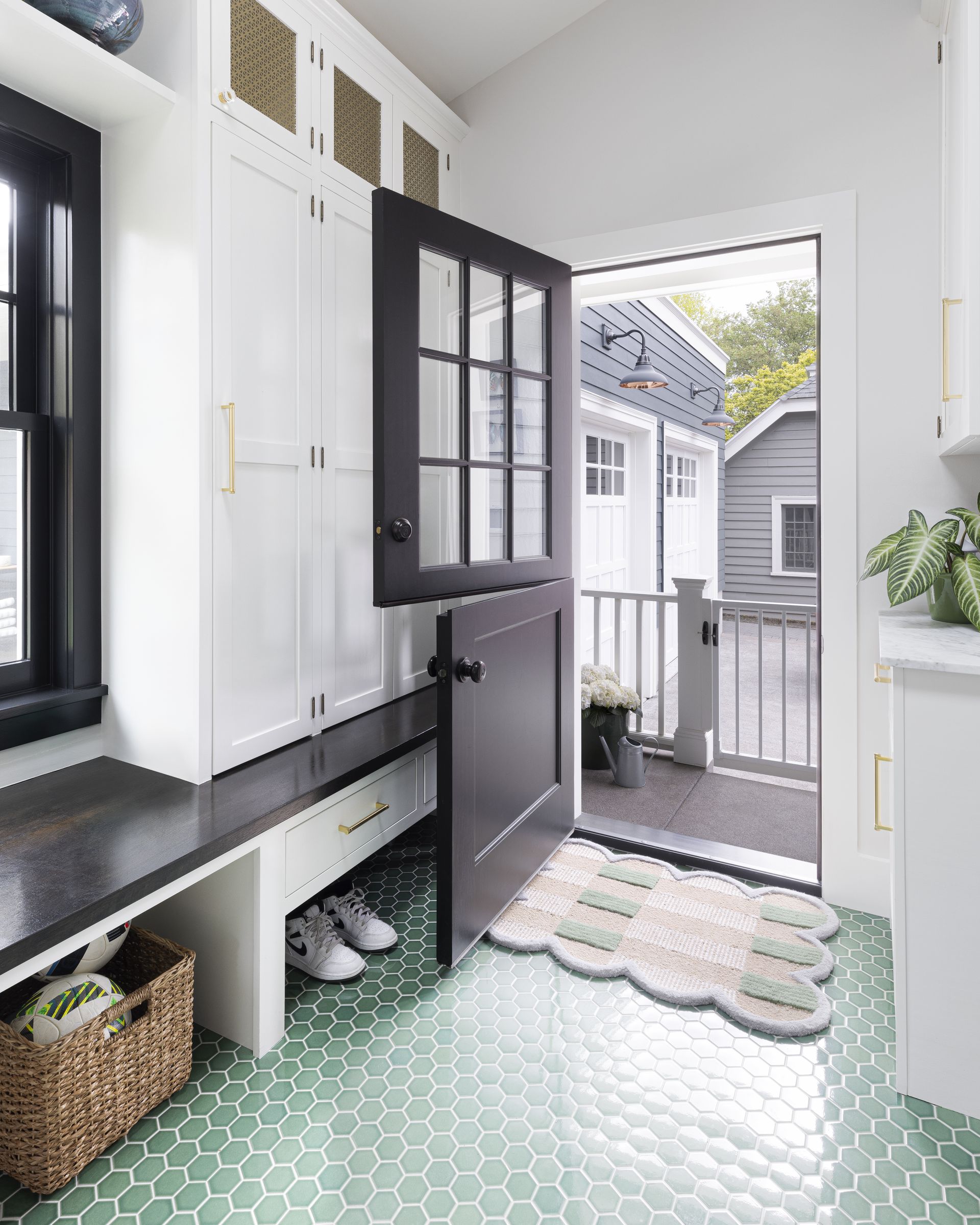 A Dutch door leads to the porch connecting with the new garage in this  1914 Laurelhurst Dutch Colonial. 