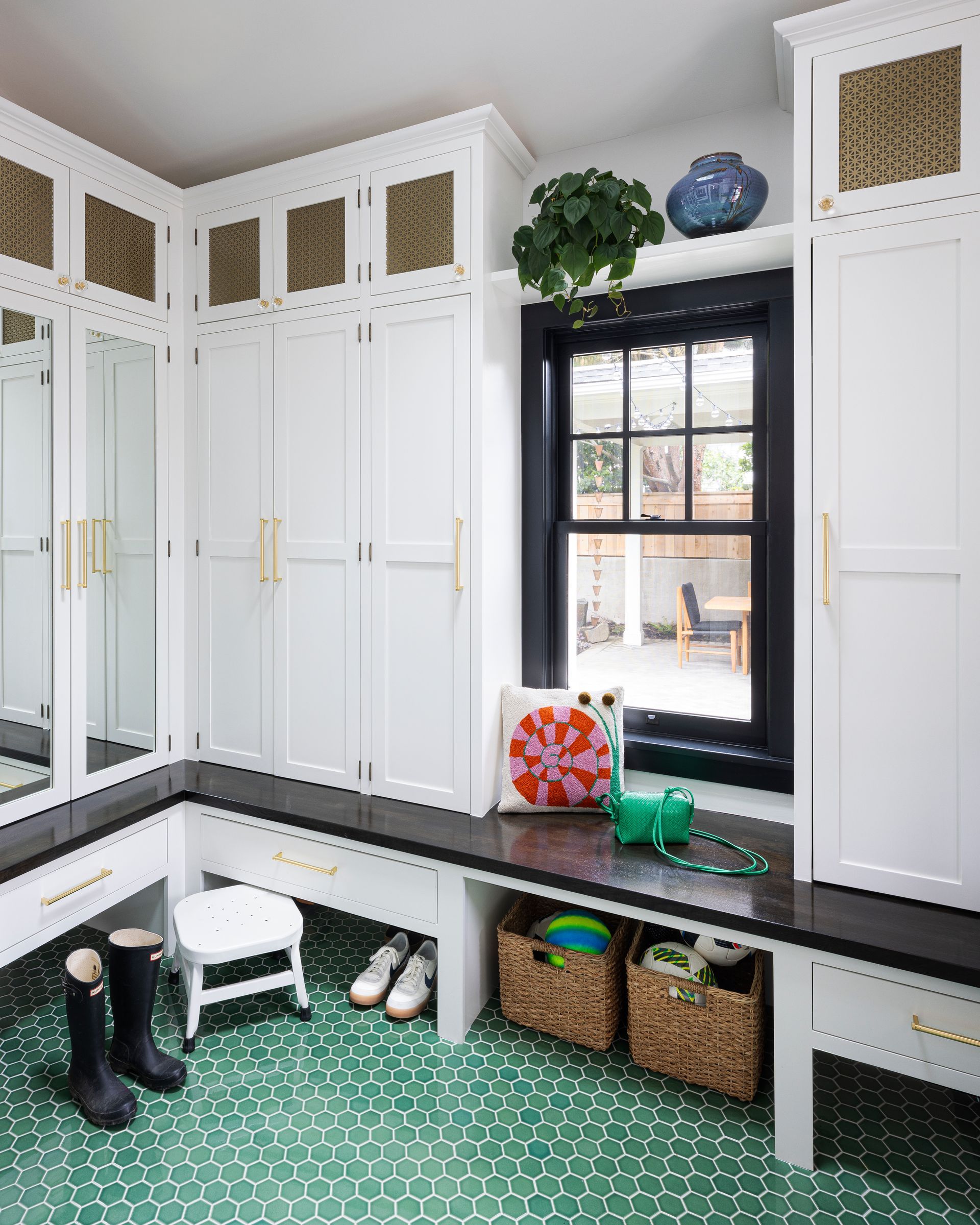 A cheery and durable green tile floor is a practical addition to the mudroom of this 1914 Laurelhurst Dutch Colonial. 