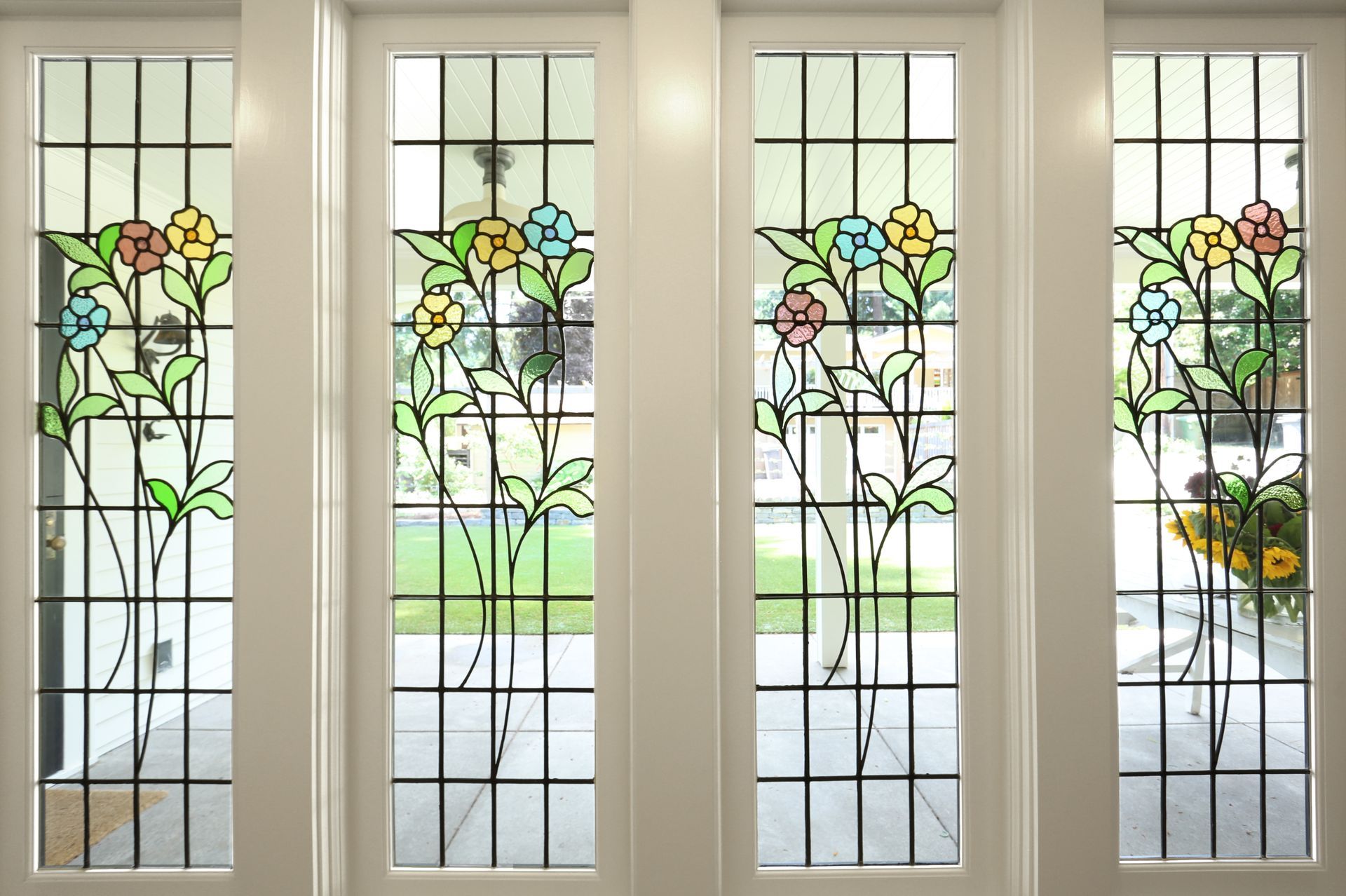 Floral stained glass windows in the breezeway.