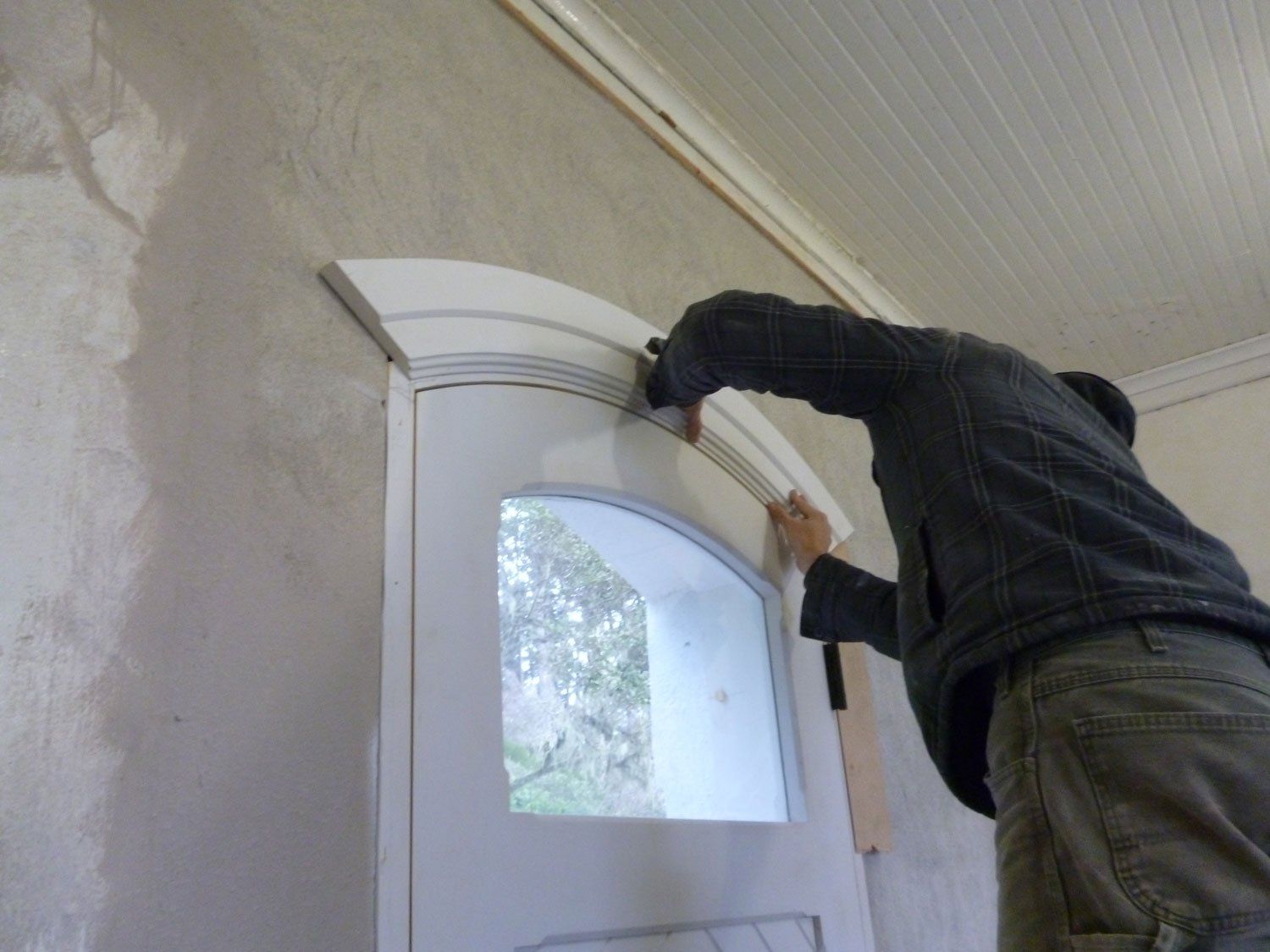 Person installing door casing at Heceta Head Lighthouse