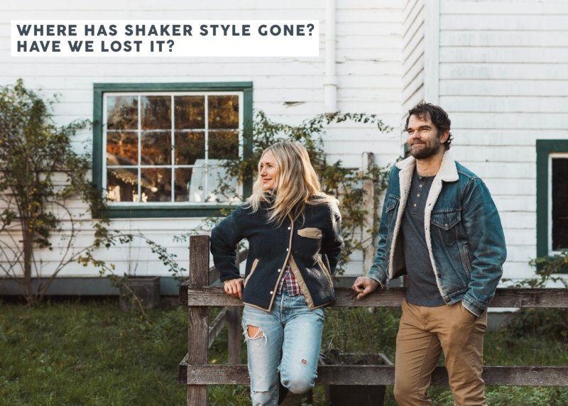 A man and a woman are standing next to each other in front of a house.