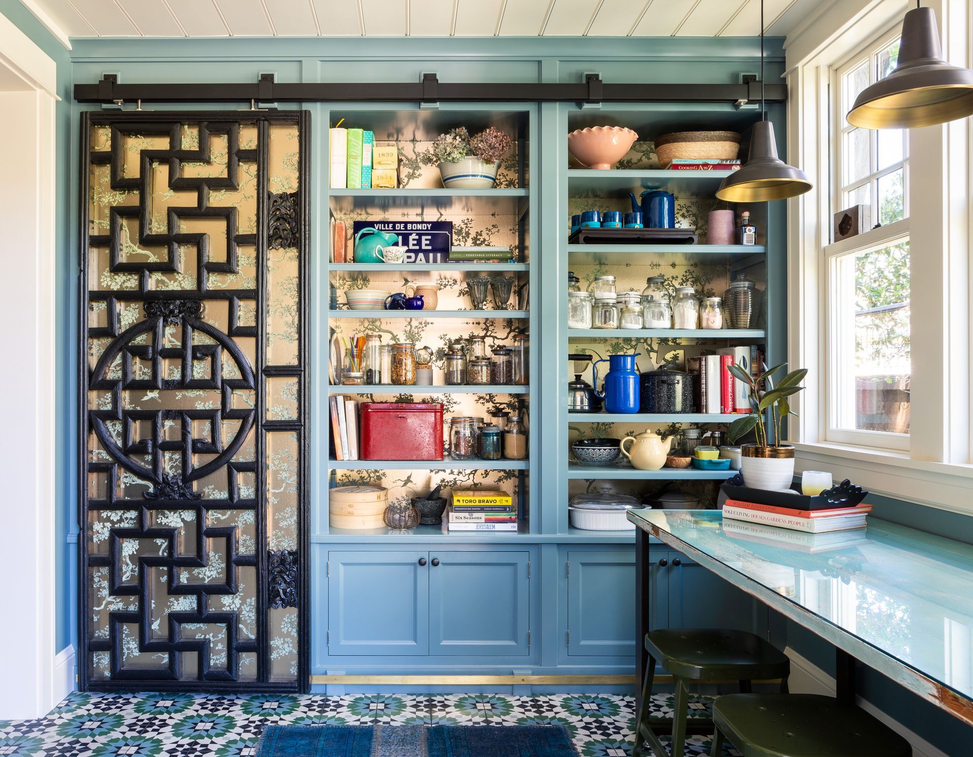 Butlers pantry cupboards in the Isam White House lined with boxing hare wallpaper by 