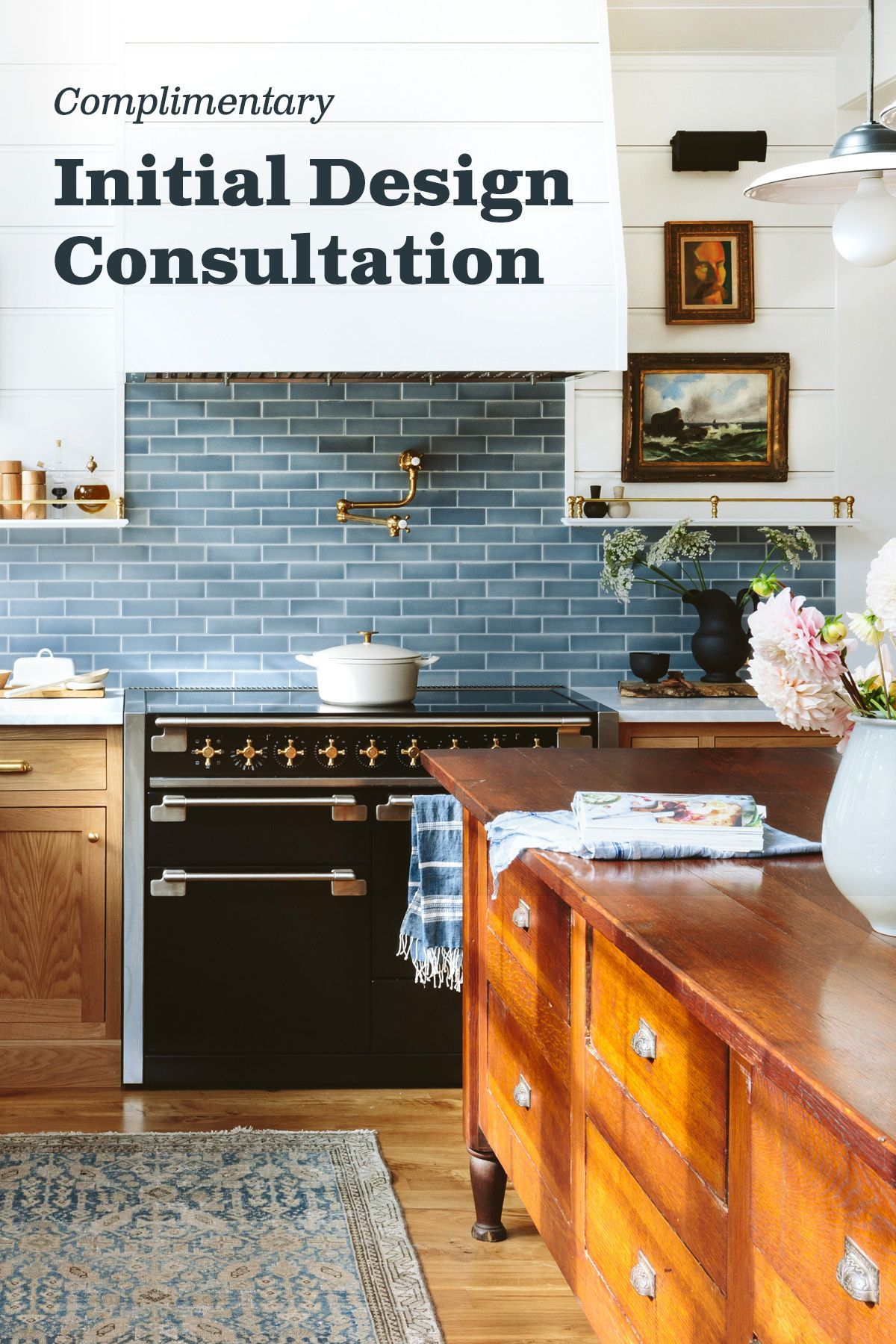 A kitchen with white cabinets and a sign that says `` free initial design consultation ''.