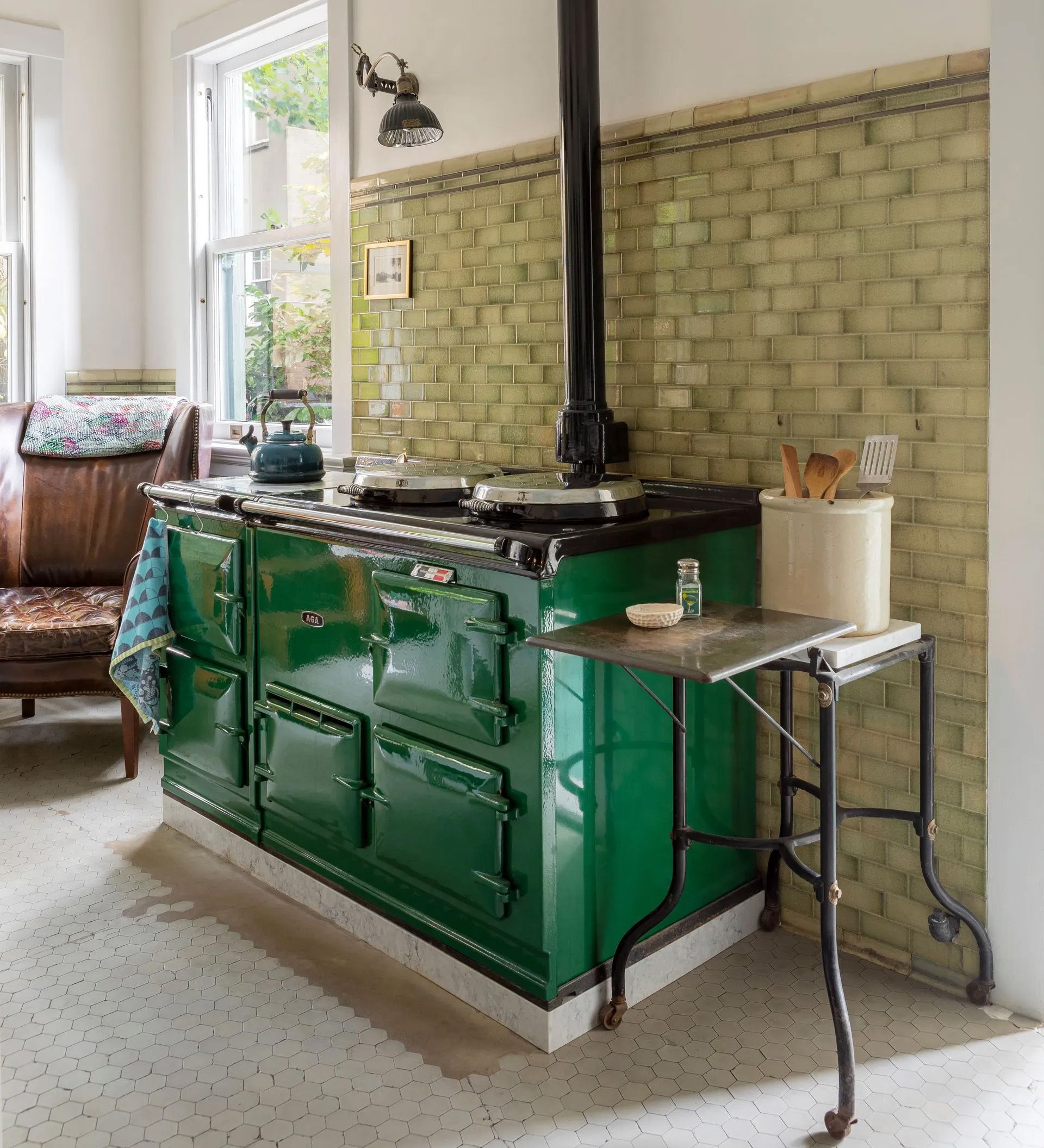 In the historic Isam White House from 1904, Arciform added a vintage Aga range with black stove pipe as a nod to the era.  Floor and wall tiles are original and were carefully preserved, keeping all their century-old imperfections.