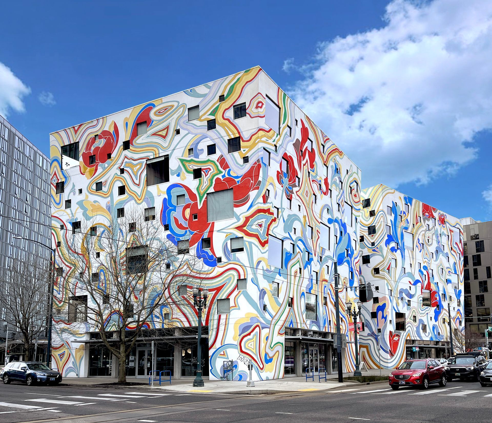 The Fair-Haired Dumbbell building is covered in a vibrant and colorful mural.