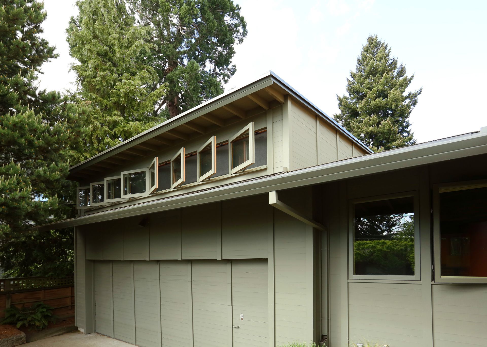 Arciform's addition to this beautifully preserved 1961 home in Alameda continues the simple siding treatment and window shape, but departs from the original by raising a shed dormer above the gently sloping roofline.