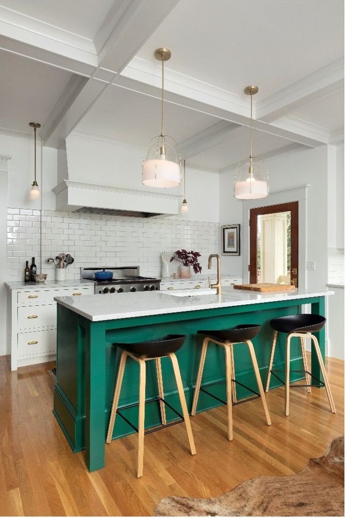A kitchen with a green island and stools