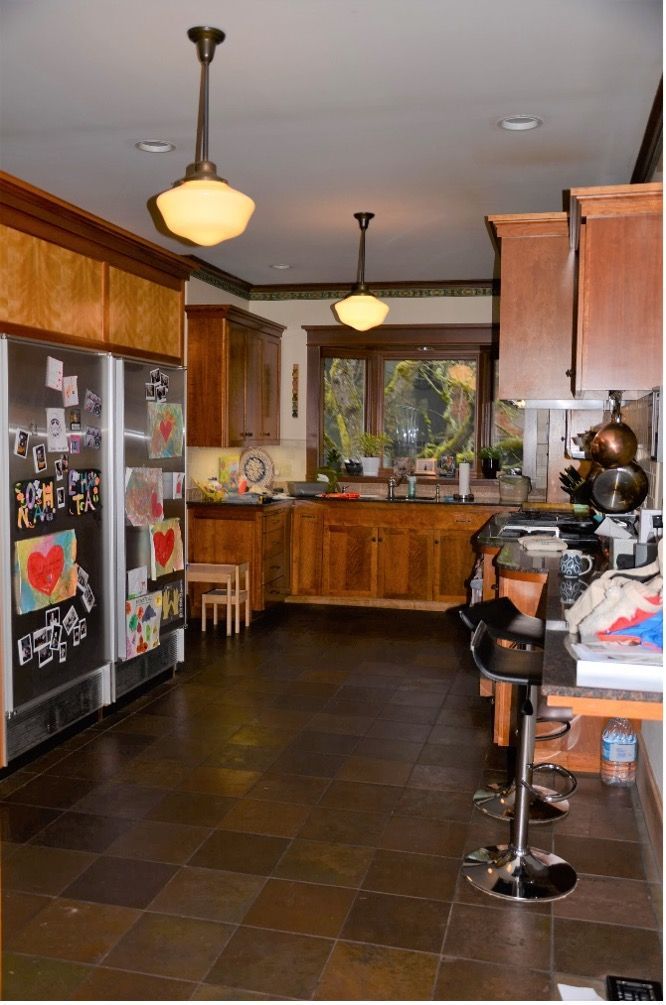 A kitchen with stools and a refrigerator that says i love you