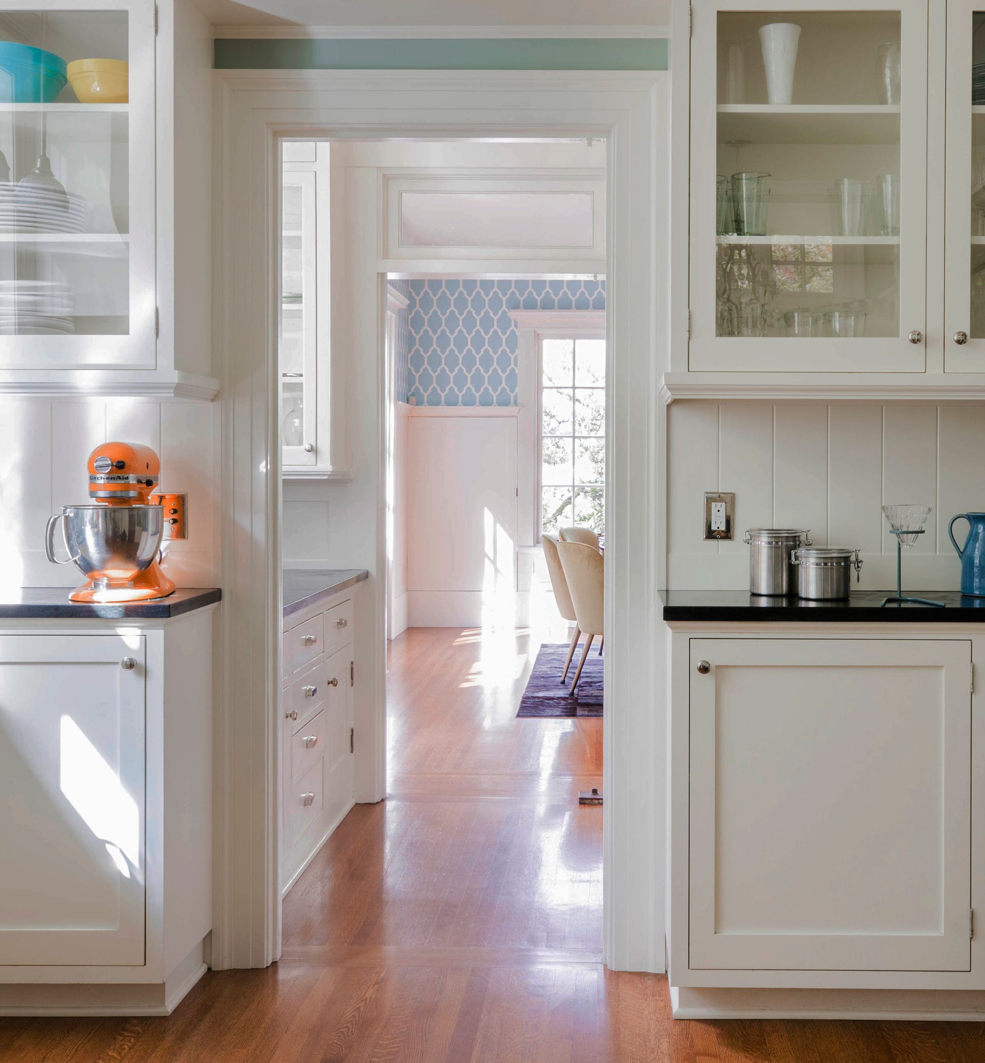 When remodeling this 1909 Portland Heights home, Arciform preserved the original pass-through butler's pantry, which provided inspiration for the new kitchen cabinets. 