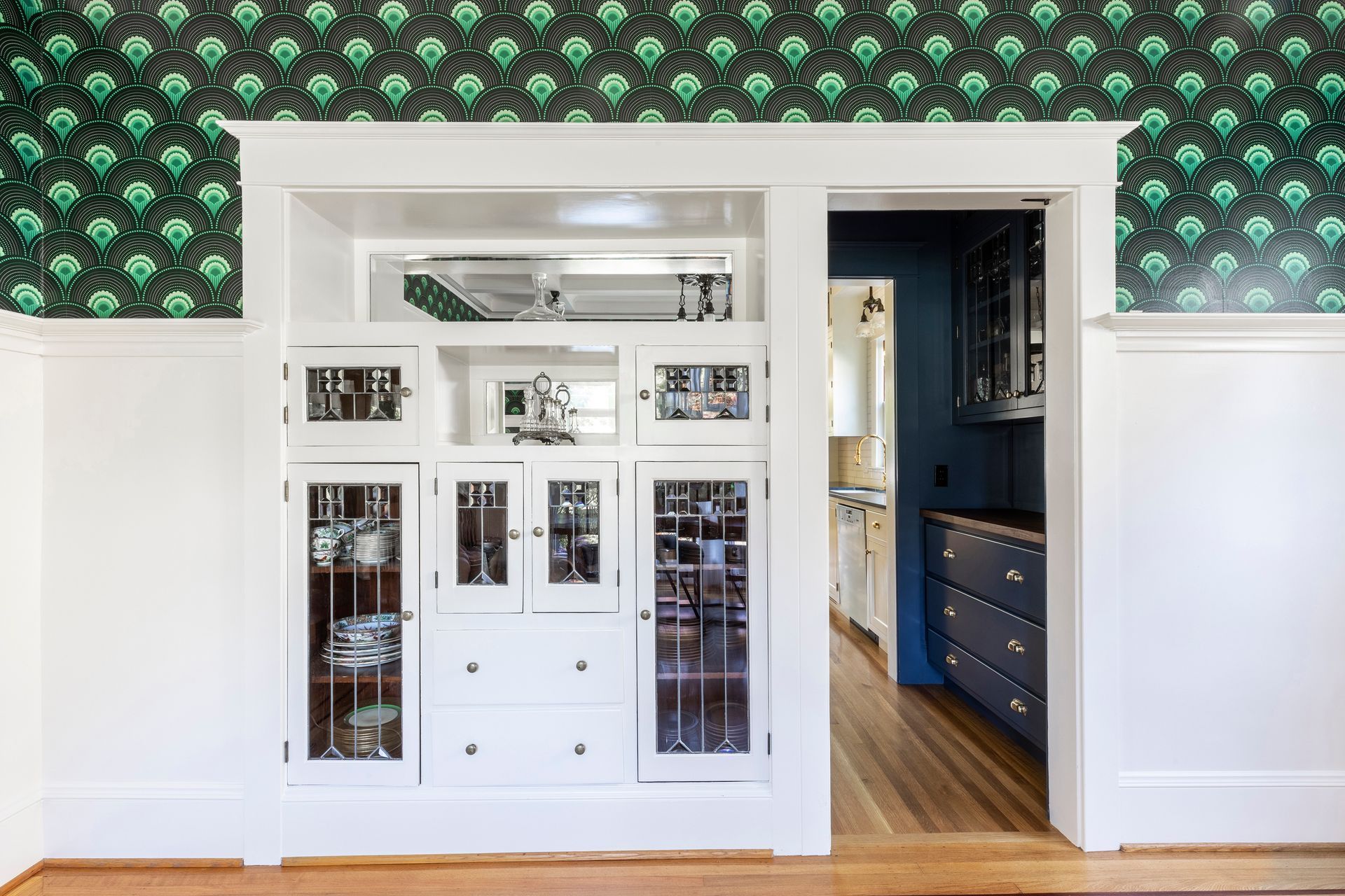 Close up of the dining room's original built-in cabinet, with contrasting wallpaper above