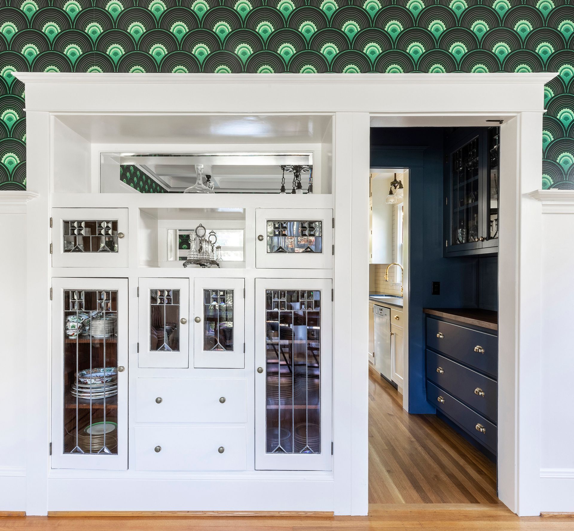 A classic pass-through butler's pantry and beautiful leaded glass built-ins define the period character of this 1911 Irvington home. As part of kitchen remodel and addition, the panty was restored and reimagined as a bar area.