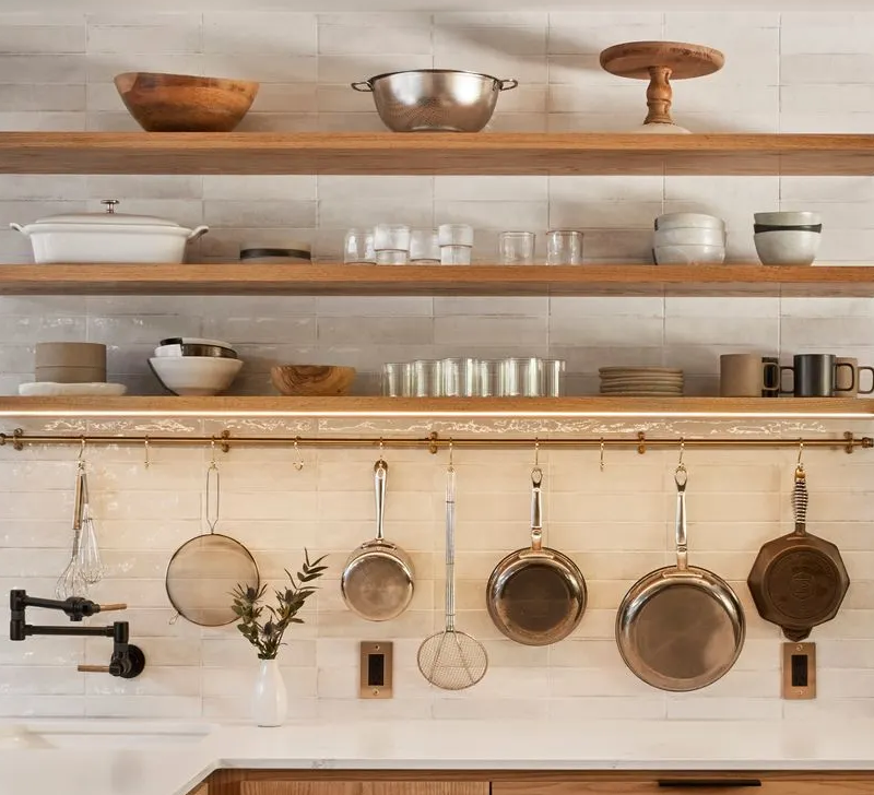 The lowest of three floating shelves in this Mt. Tabor kitchen features integrated LED strip lighting. 