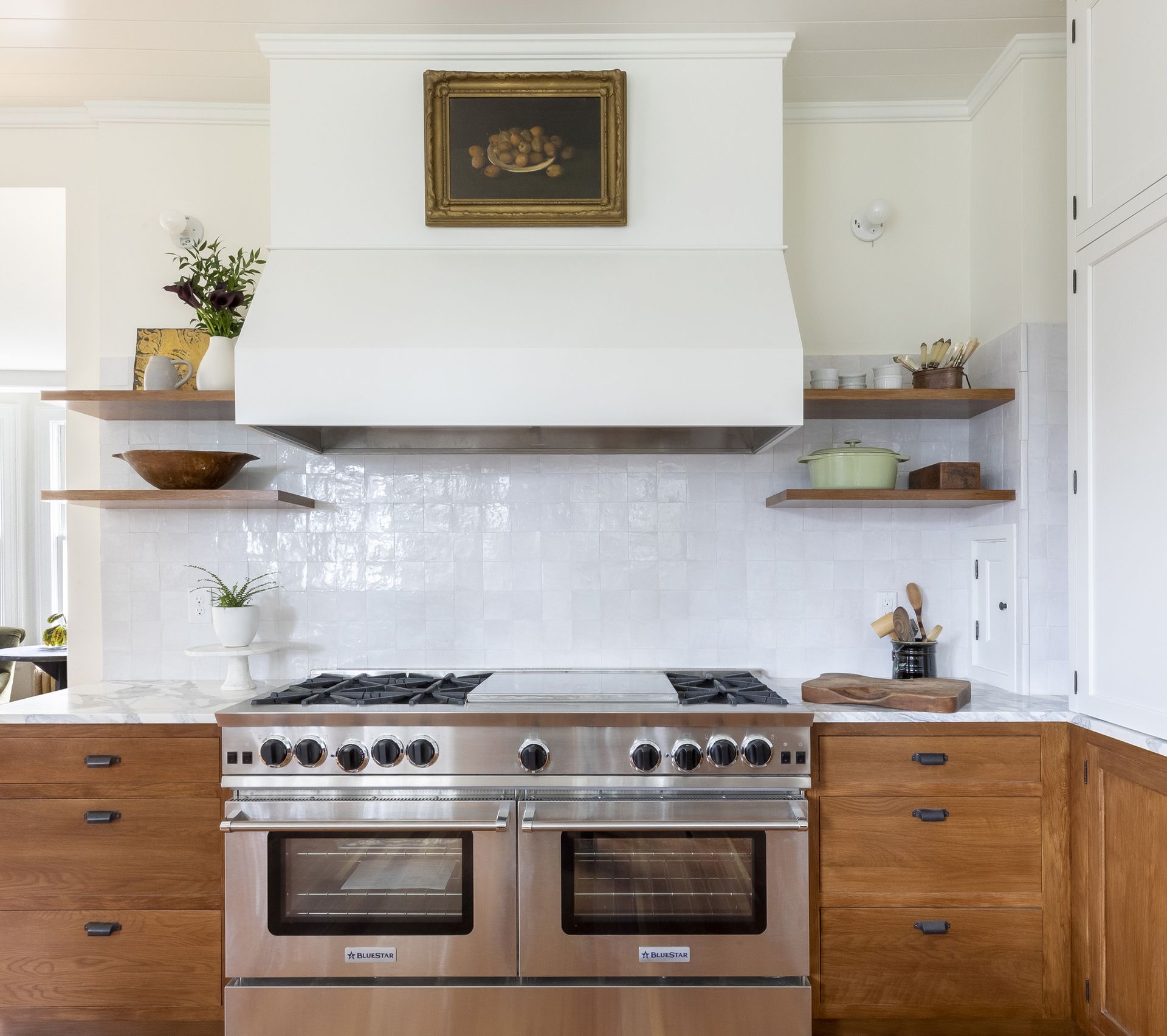 Small floating shelves on either side of the range hood add a modern touch to this vintage-style kitchen Arciform designed for a historic Mt. Tabor home.