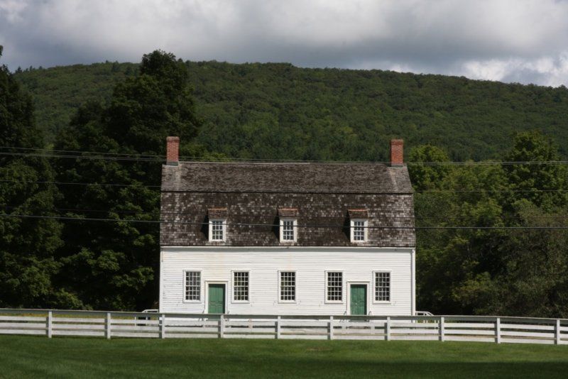 A white house with a fence in front of it