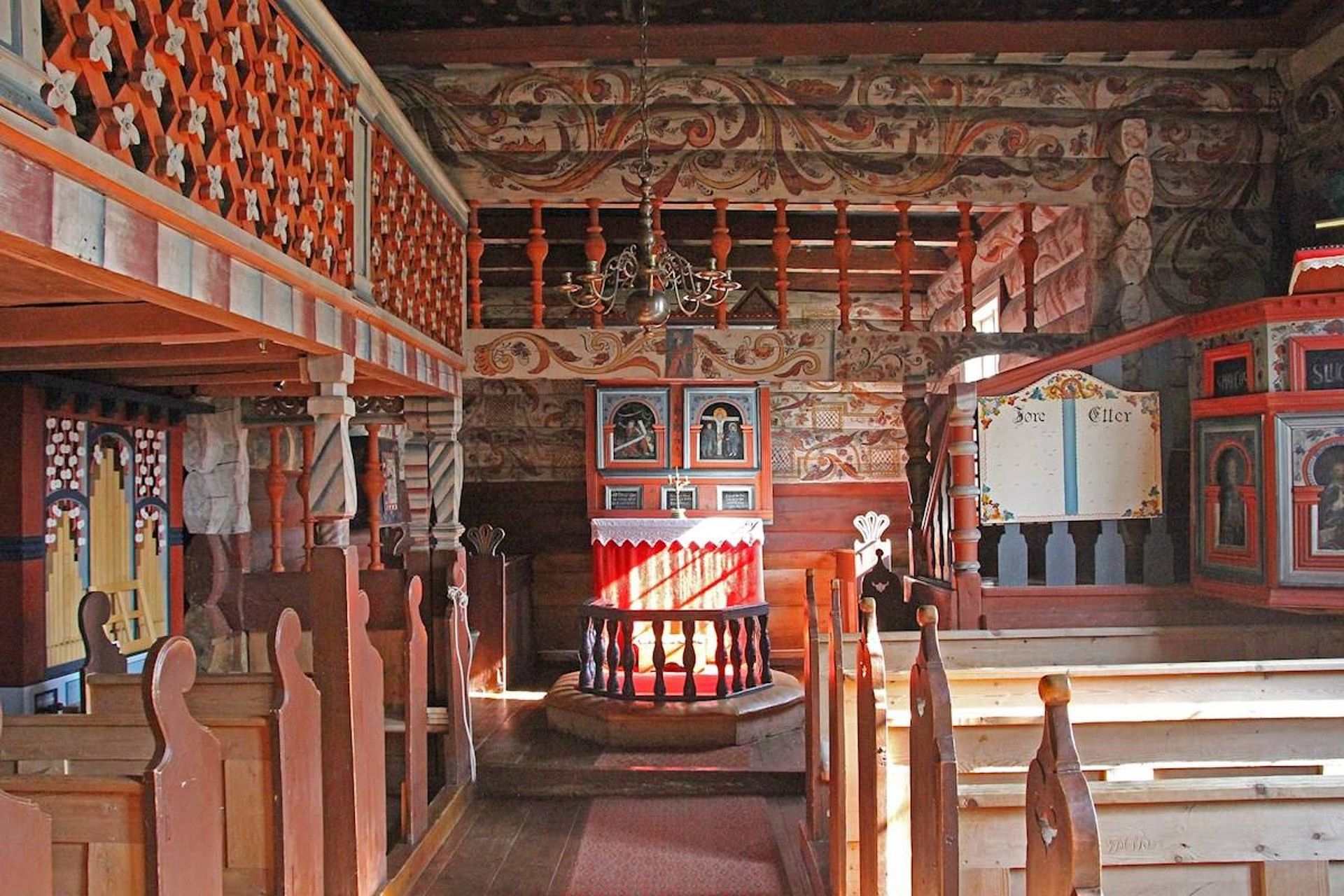 Folk art designs in cheerful red and blue cover the interior of this 18th century Norwegian church.