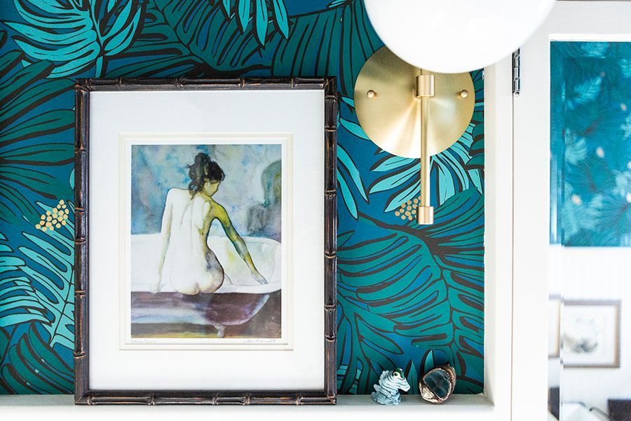 The WCs door has an antiqued mirror panel which leads you to the original bath, decked out in colors of the sea with crisp white trim.