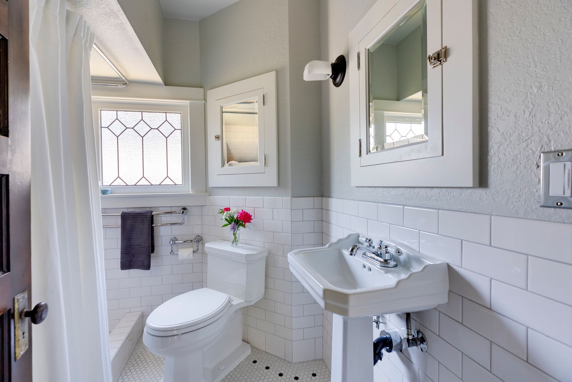 This 1913 bathroom remodel illustrates one approach to bathroom design that is appropriate to Piedmont's vintage homes.  Some original elements were carefully preserved or replicated, while others, such as the mahogany vanity were custom designed to suit the period but also meet the modern need for two sinks and ample storage. 