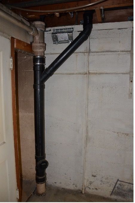Exposed plumbing stack in basement