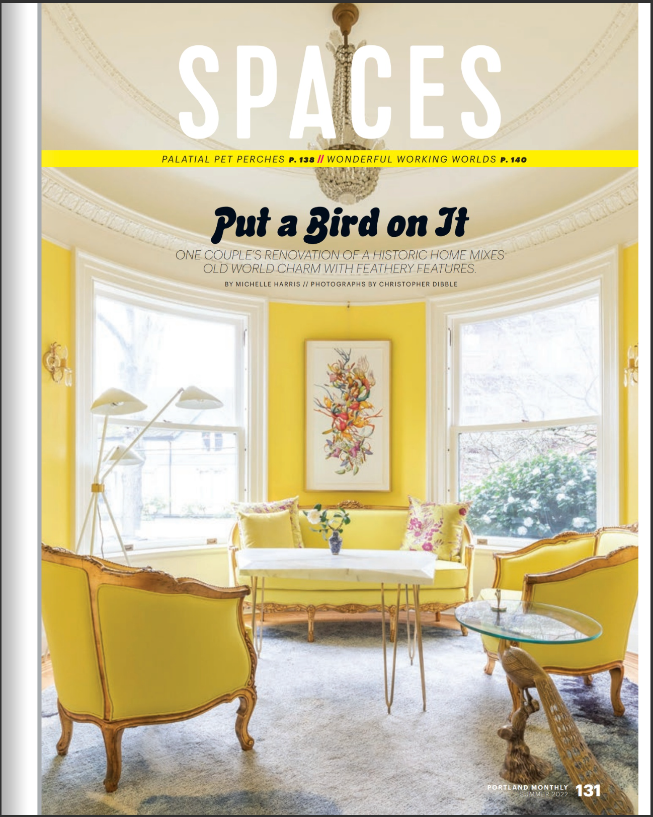 A living room with yellow walls and yellow chairs on the cover of a magazine called spaces.