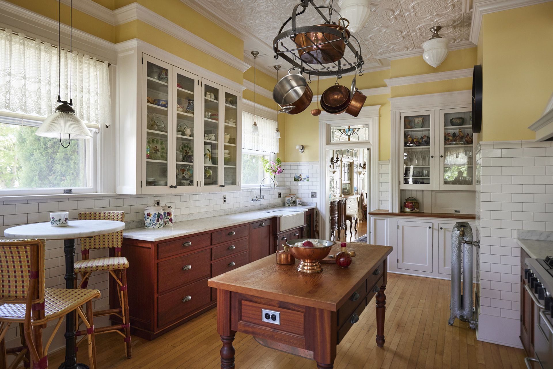 Kitchen view looking from the back of the house toward the dining room. The pro gas range is on the right with the island at the center of the room.