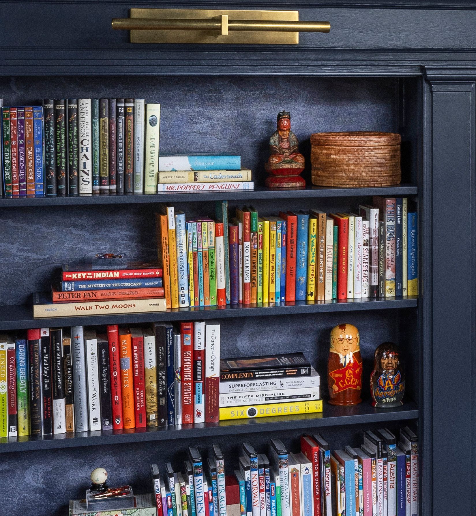 The tone-on-tone wallpaper within this built-in bookcase adds a subtle treat for the eyes—an unexpected but lovely detail.