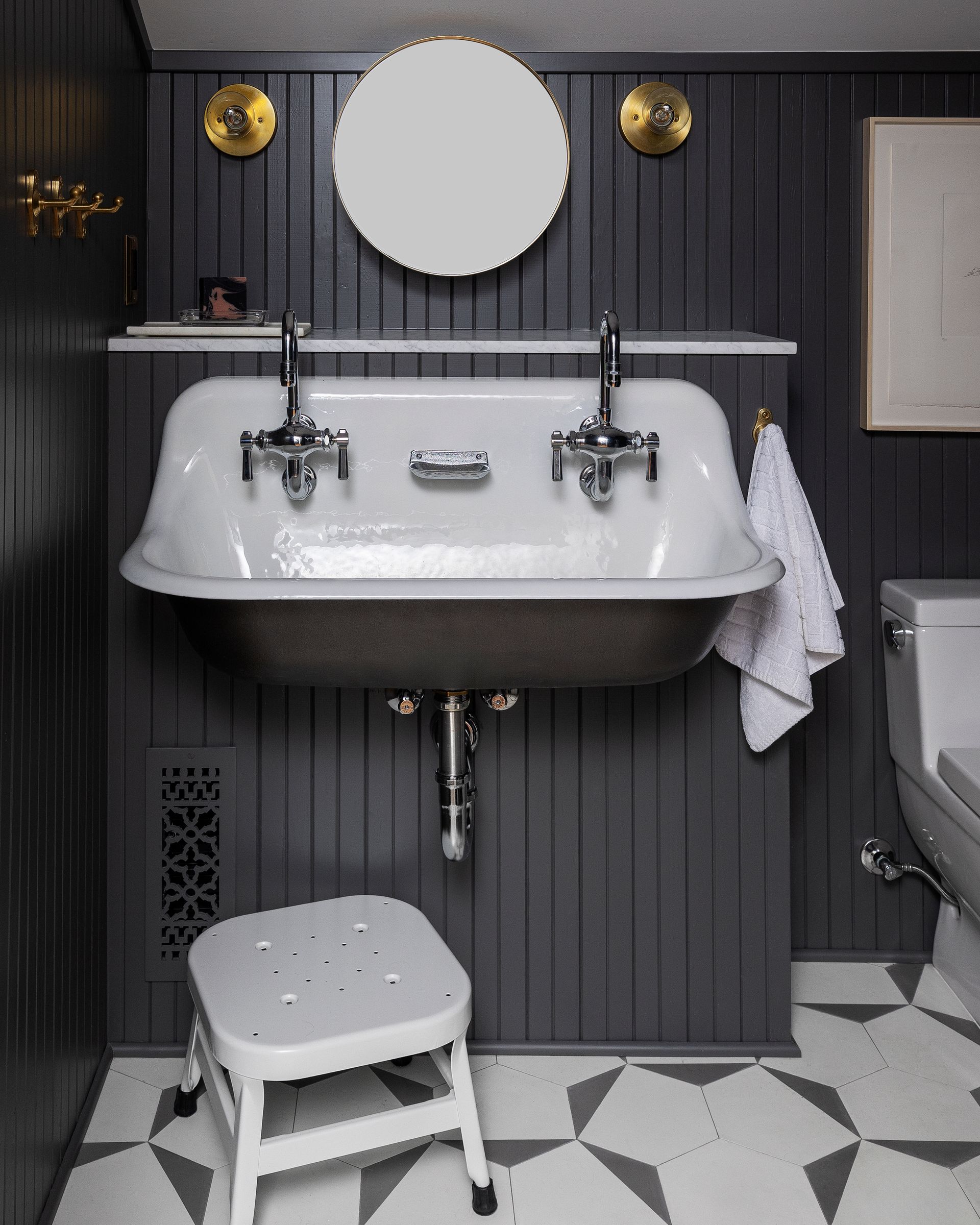 In a small attic bathroom designed for two boys, a double wall mount sink adds functionality, as well as a big dose of vintage charm. 