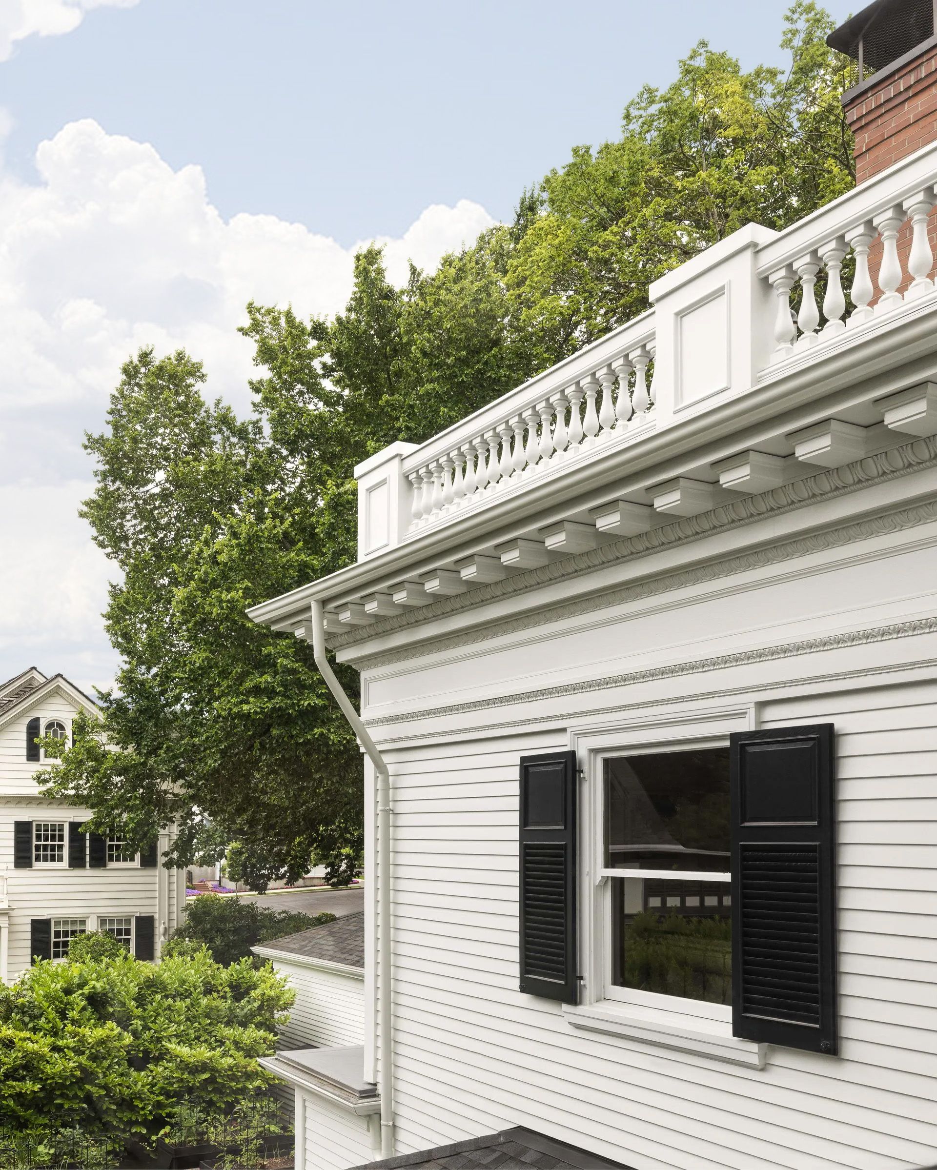 There is a desk and chair in the room with a lot of windows.