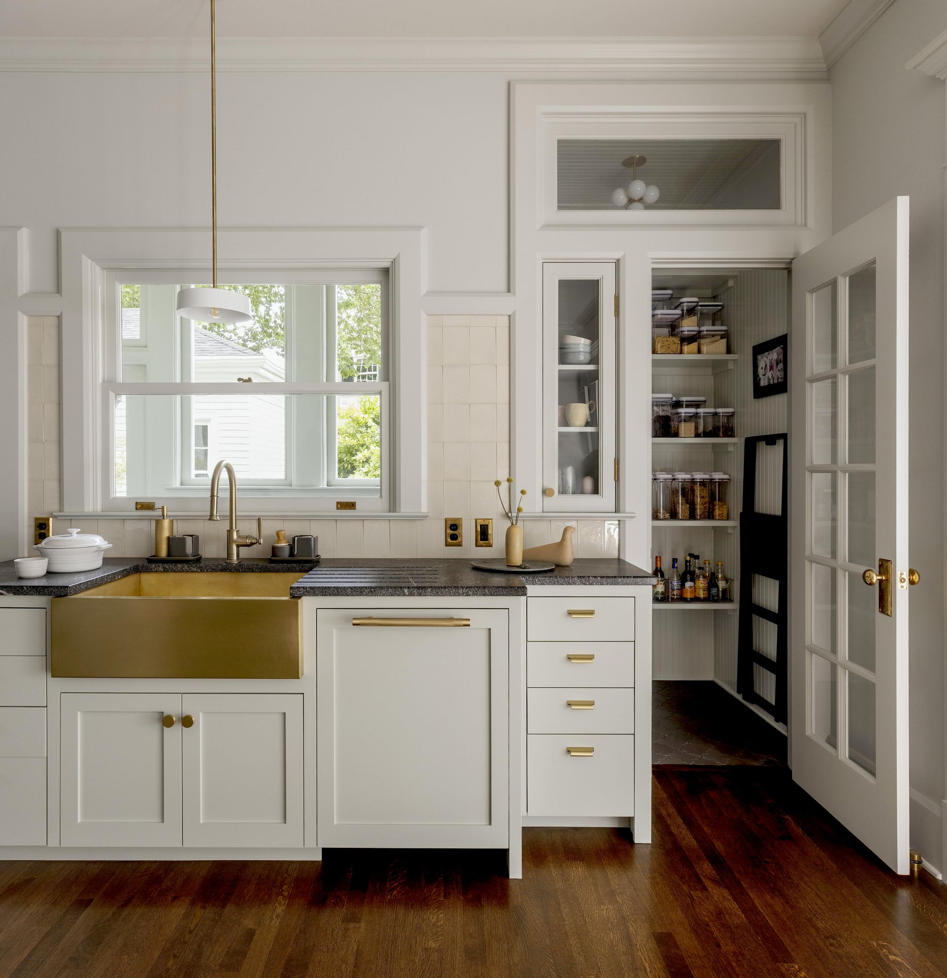 On the other side of Pam and Chris's kitchen a second work zone with more fitted cabinets, a small tucked in cupboard, and a full walk in pantry provides tons of extra storage. 