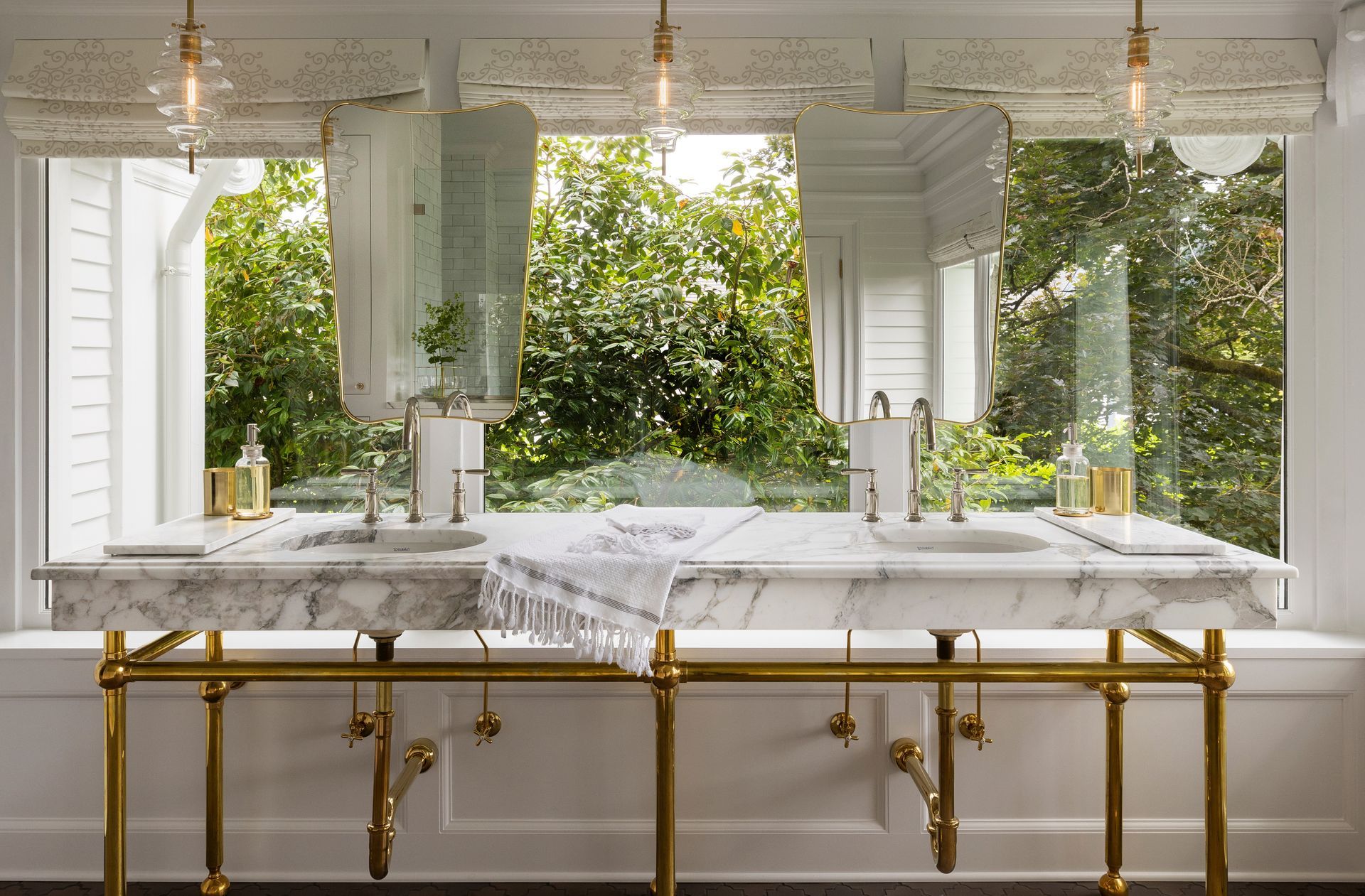 A large sleeping porch in a Portland Heights colonial revival home was converted into a luxurious primary bath. The huge windows open the space to tree-top greenery and views of downtown and distant mountains.