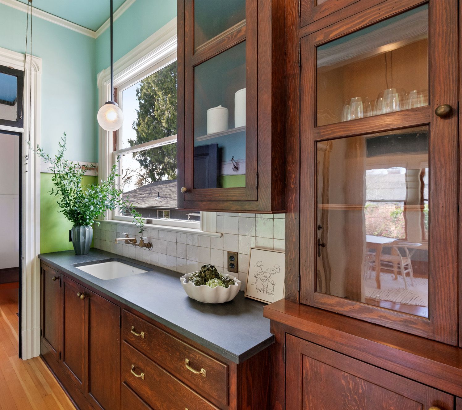 For an 19th century Portland Victorian, Arciform created a walk through pantry with new period-style cabinets and soapstone counters. 