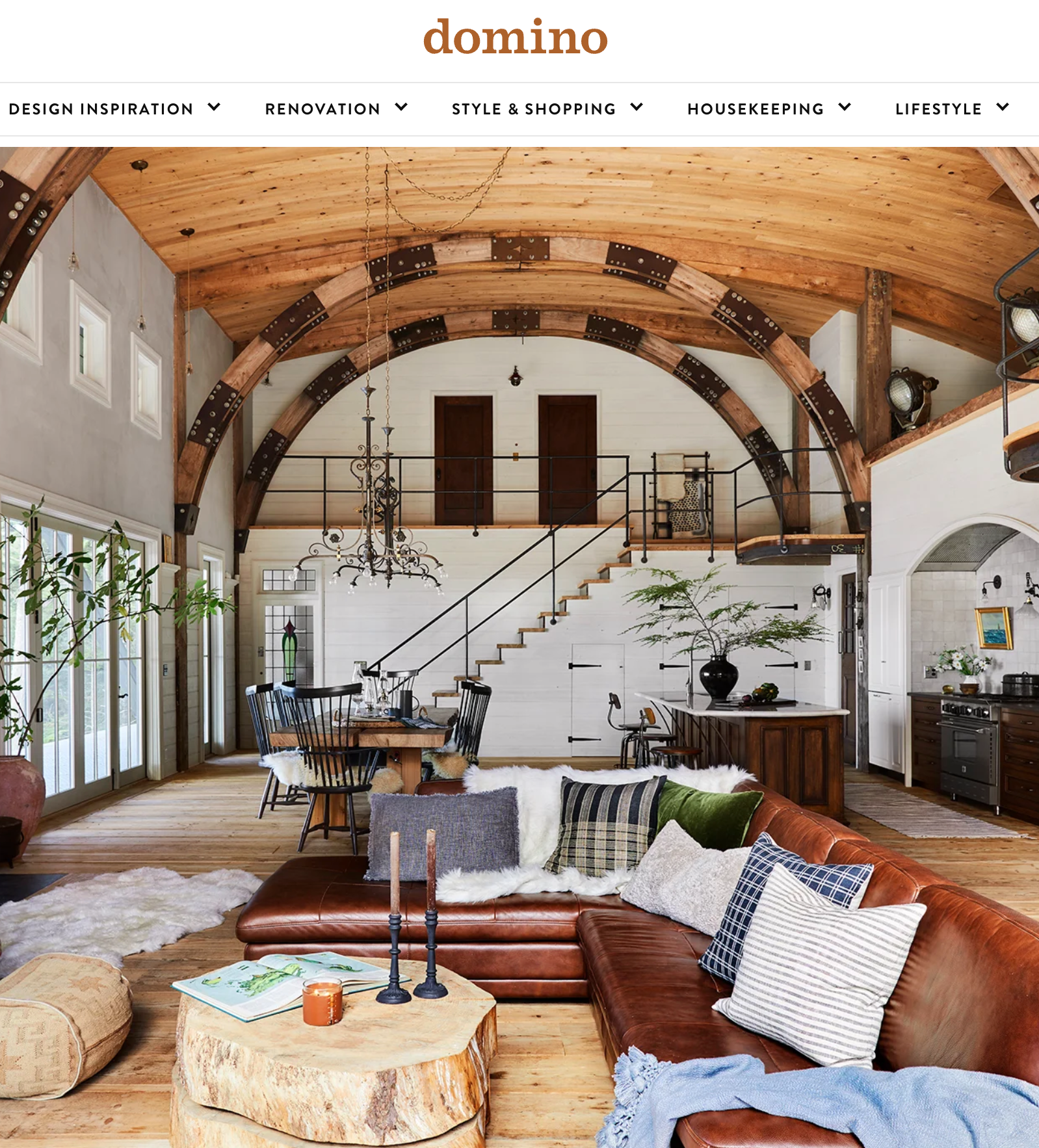 A living room with a couch and a table on the domino website