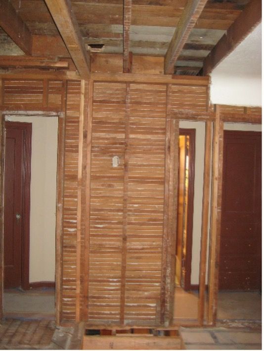 A room with a wooden wall and two doors
