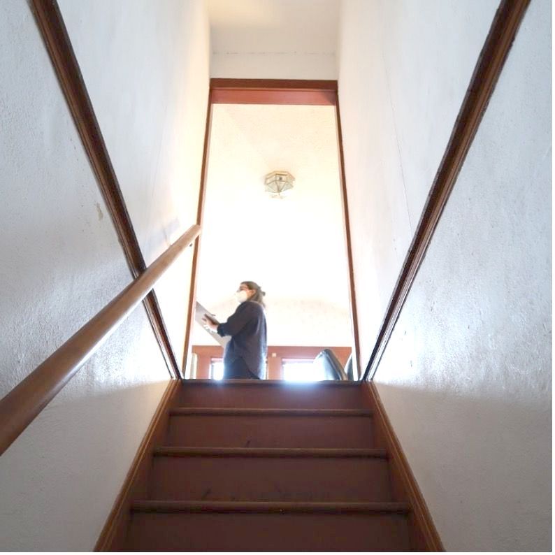 A person standing on a set of stairs looking up