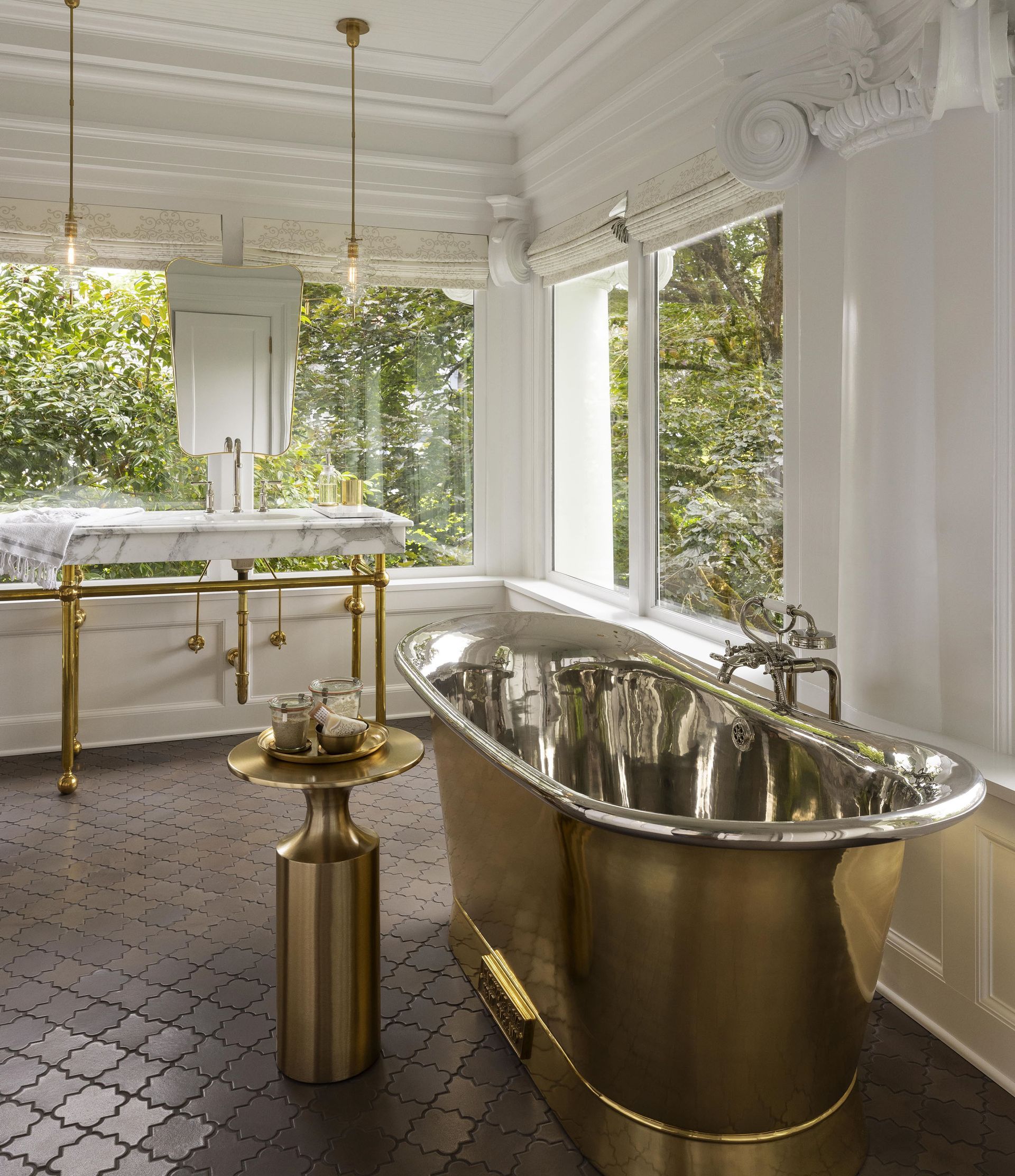 In this 1913 home, we converted a seldom-used sleeping porch into stylish and light-filled primary bath which includes a double marble and brass console sink, brass soaking tub, and a spacious walk-in shower.