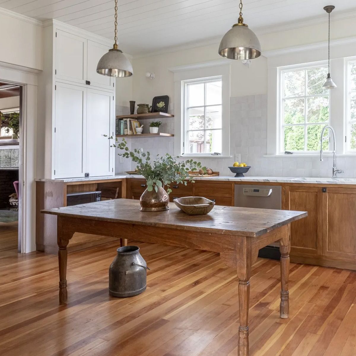 An antique work table maintains its original function as the center point of this period-style Mt. Tabor kitchen remodel.